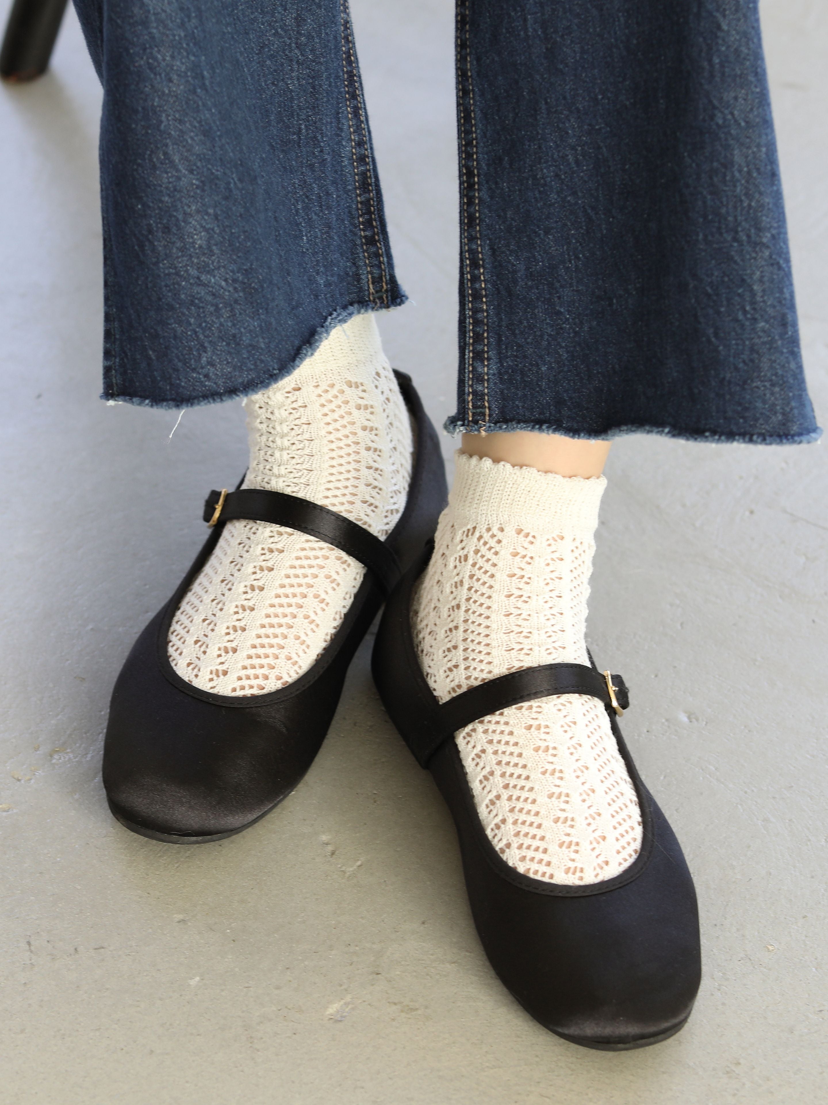Tabio Irmack Mesh Ankle Socks featured with black flats, showcasing classic lace pattern for a feminine touch. Color: White.