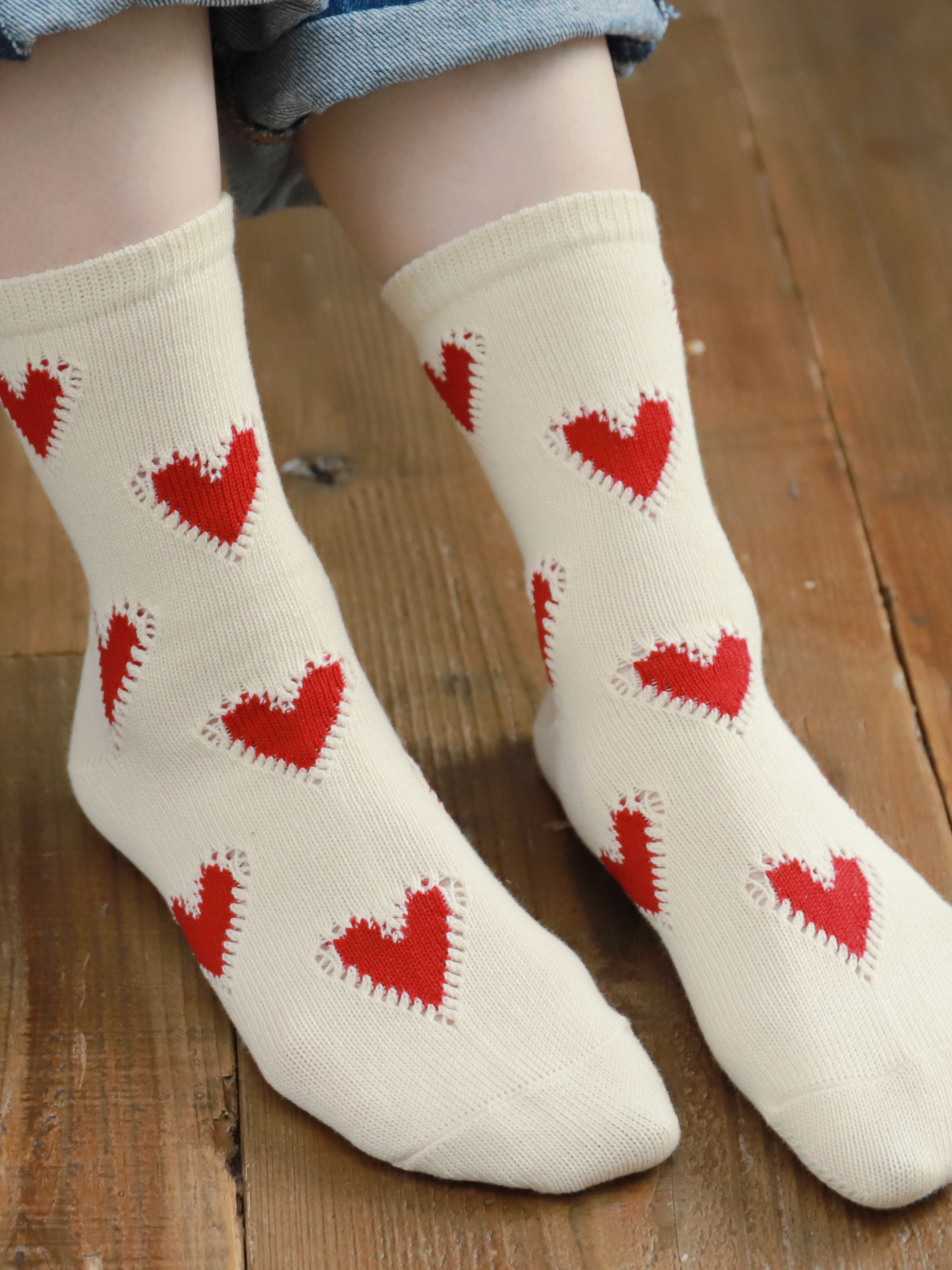 Tabio Colorful Hearts Socks showcased on model, featuring vibrant red hearts on ecru, perfect for year-round wear.