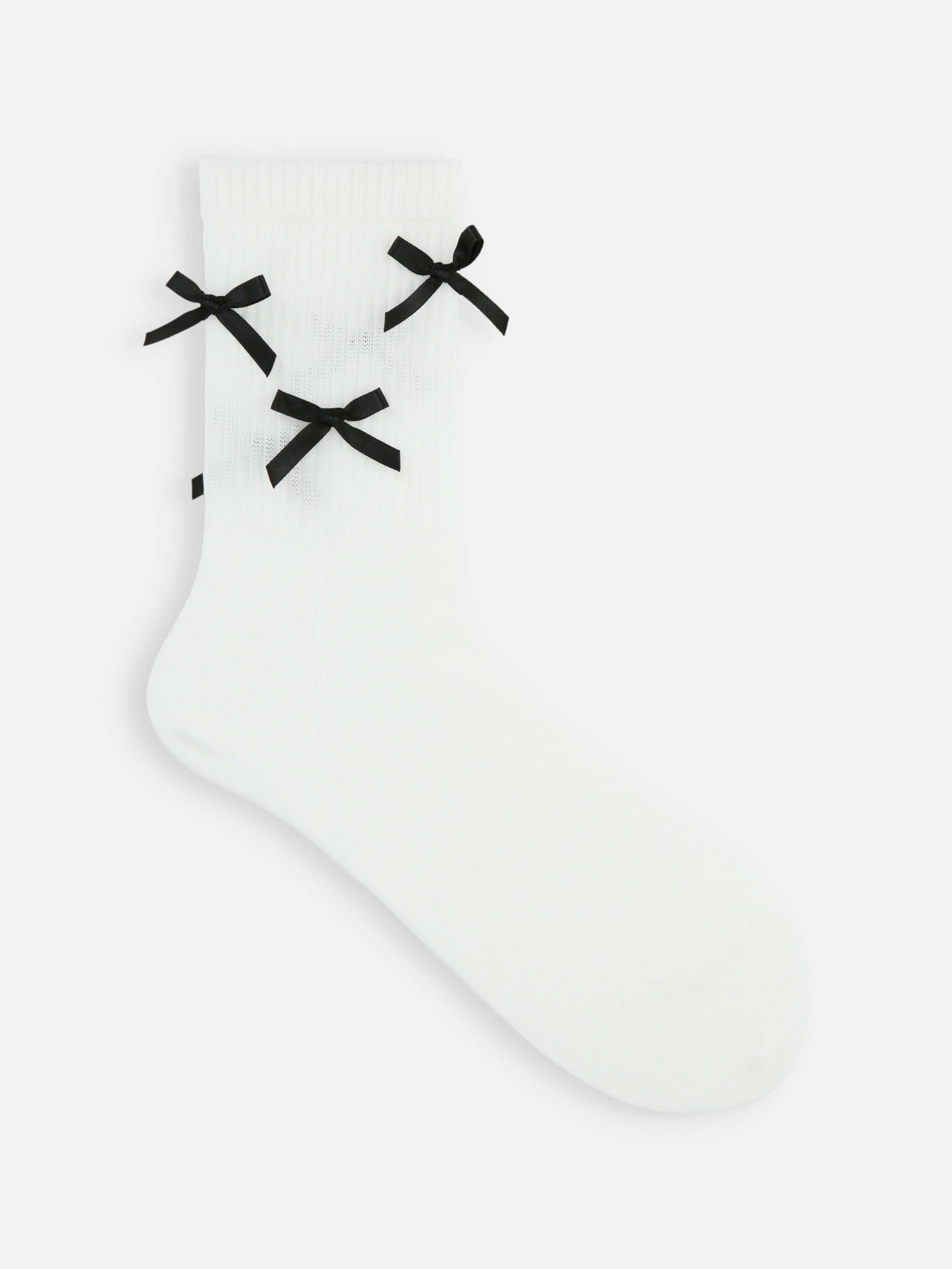 Tabio Satin Ribbons Crew Socks, side view of white ribbed socks with black satin bows for an elegant and trendy look.