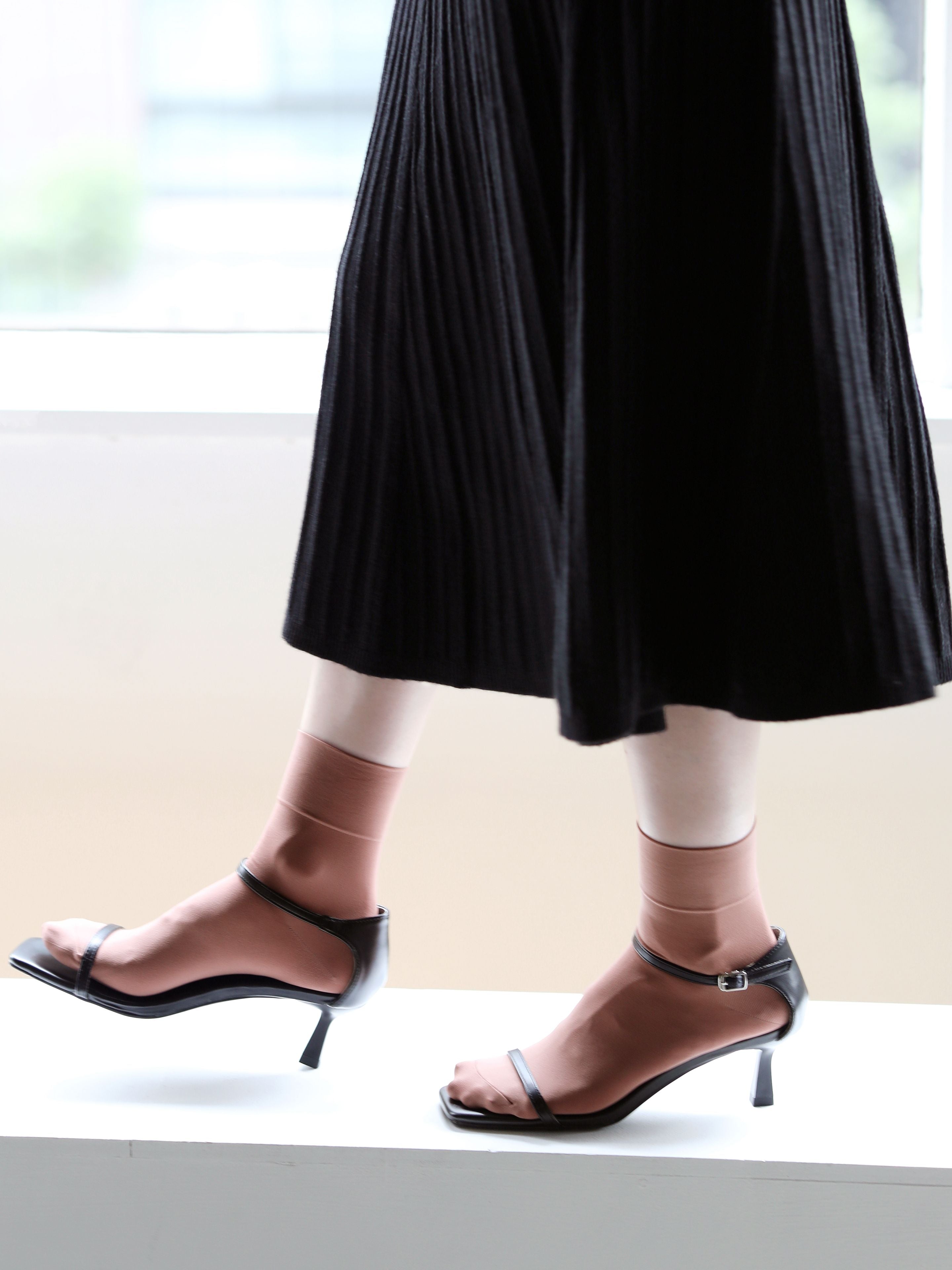 Tabio Soft Nylon Socks showcased with a stylish heel, highlighting their softness and stretch in an elegant look.
