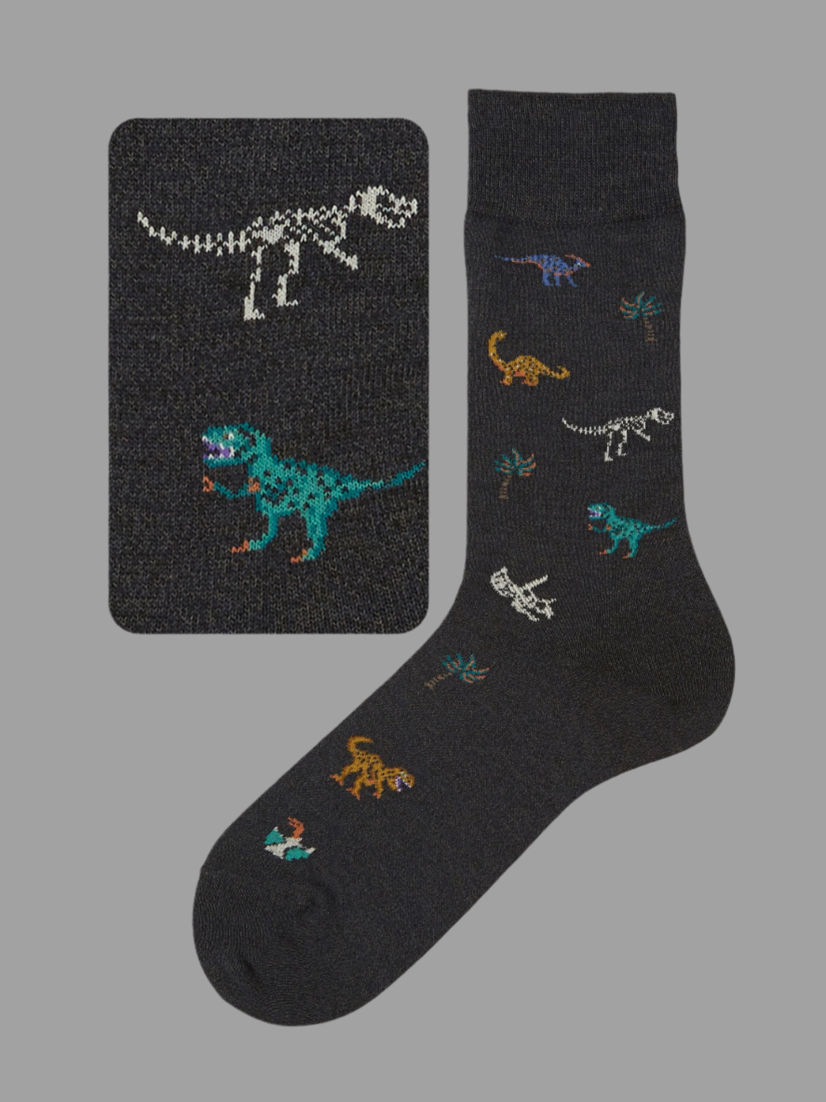 Tabio. Dinosaur-Pattern Crew Socks featuring colorful dinosaur motifs on premium cotton, displayed on a dark background.
