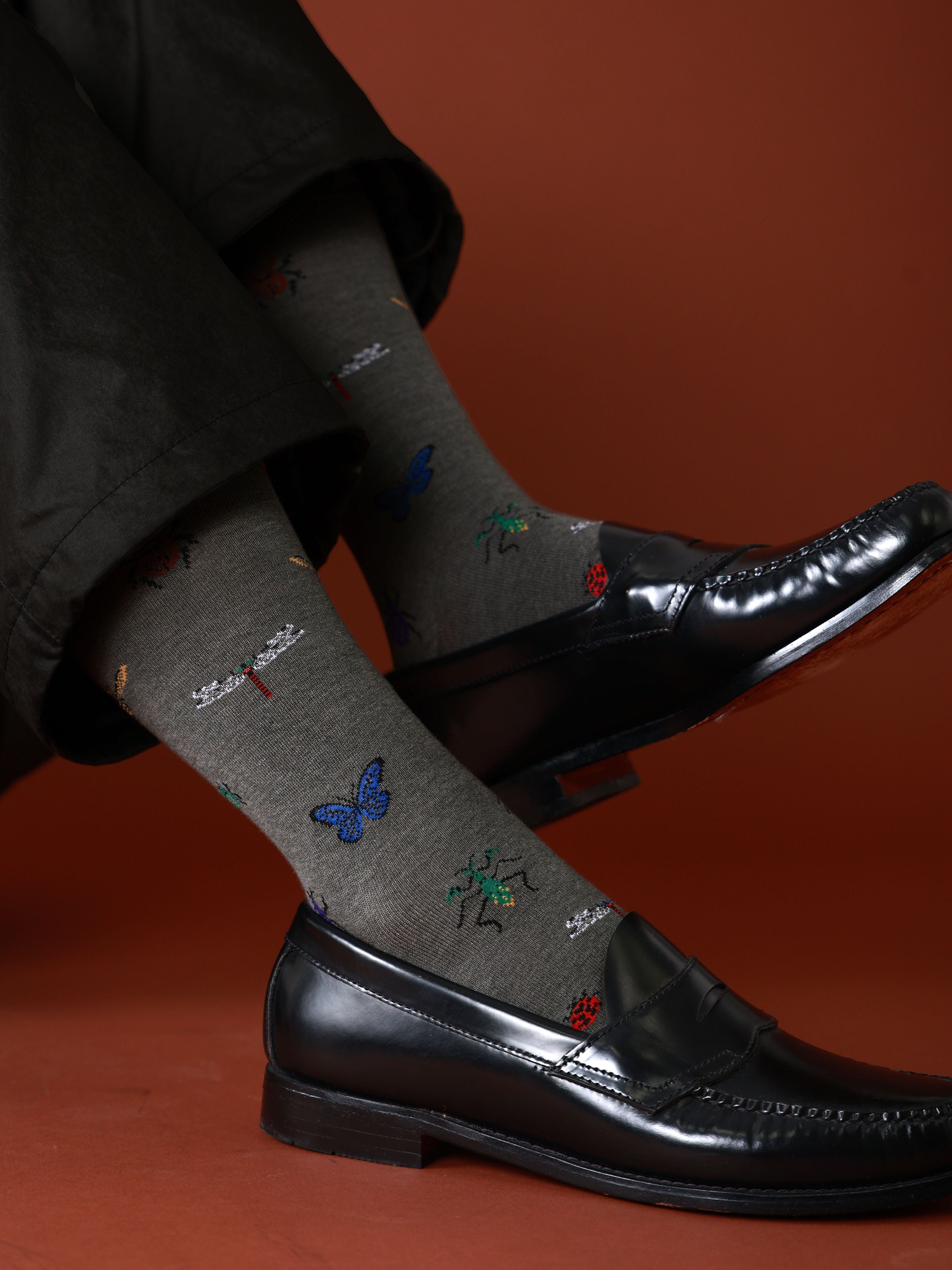 Tabio. Dragonfly-Pattern Crew Socks displayed on a model, showcasing the intricate dragonfly and insect designs in vibrant colors.