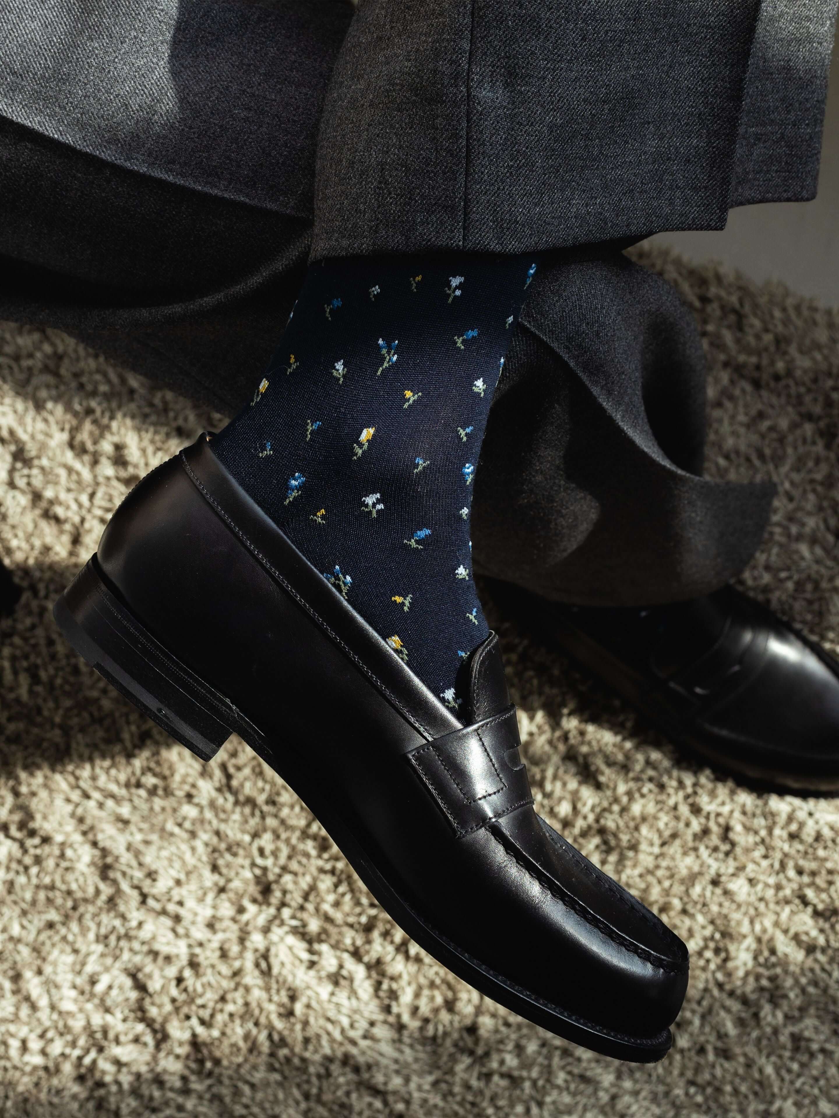 Tabio Supima Small Floral Print Socks showcased on a model's foot, featuring a dark navy background with colorful floral.