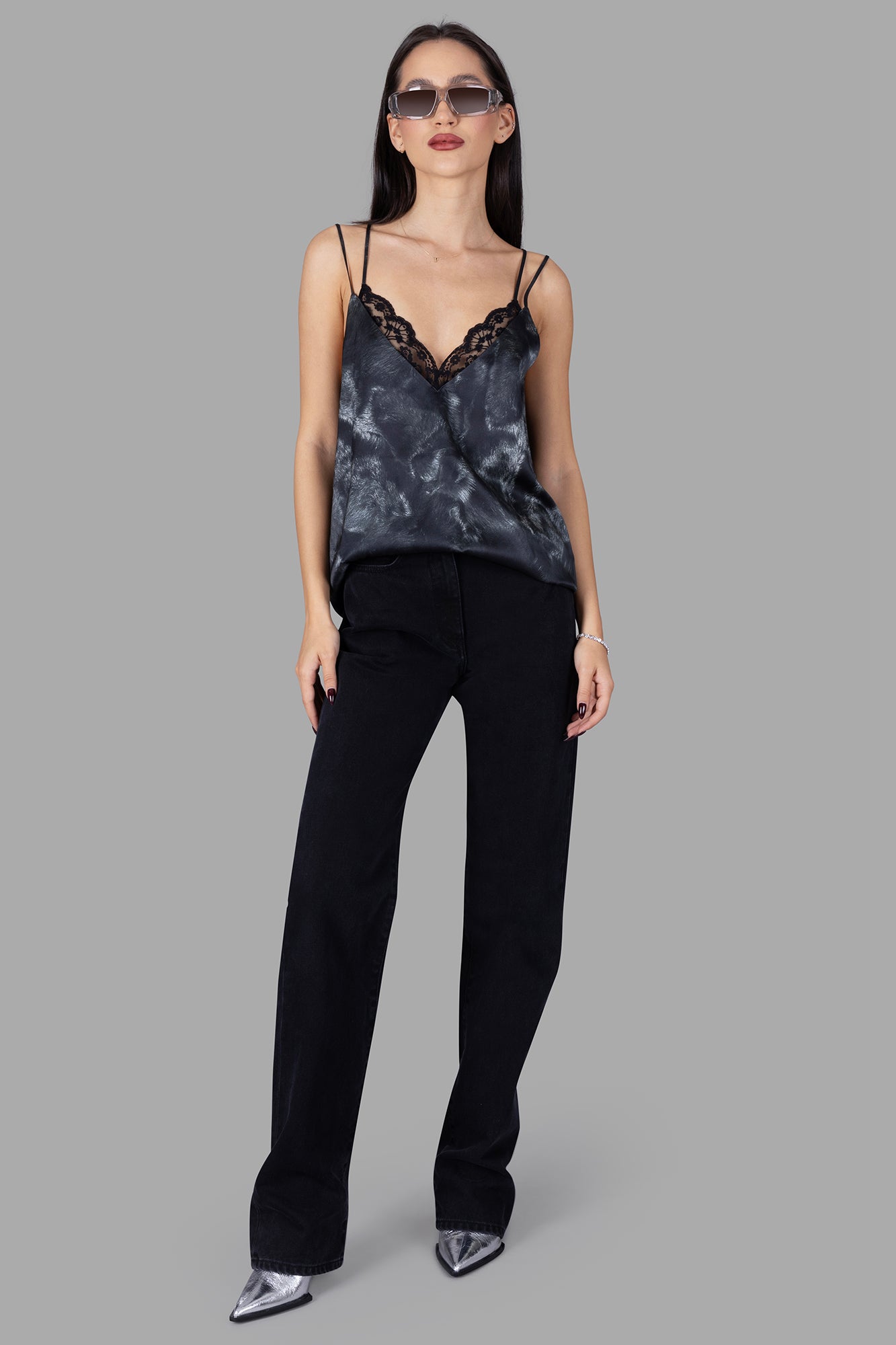 Natasha Zinko black spaghetti-strap top with lace detailing, V-neck, and open back, shown on model.