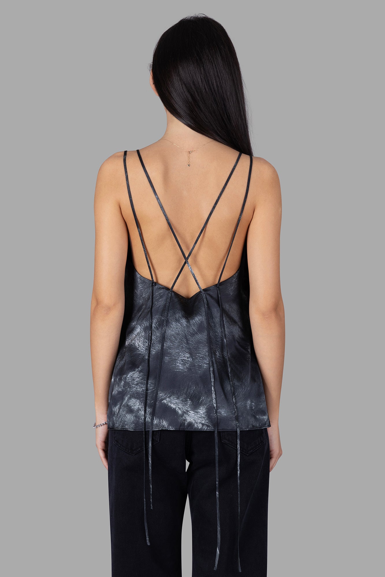 Natasha Zinko Spaghetti-strap Top featuring a unique lace detail and an open back with crisscross straps in black.