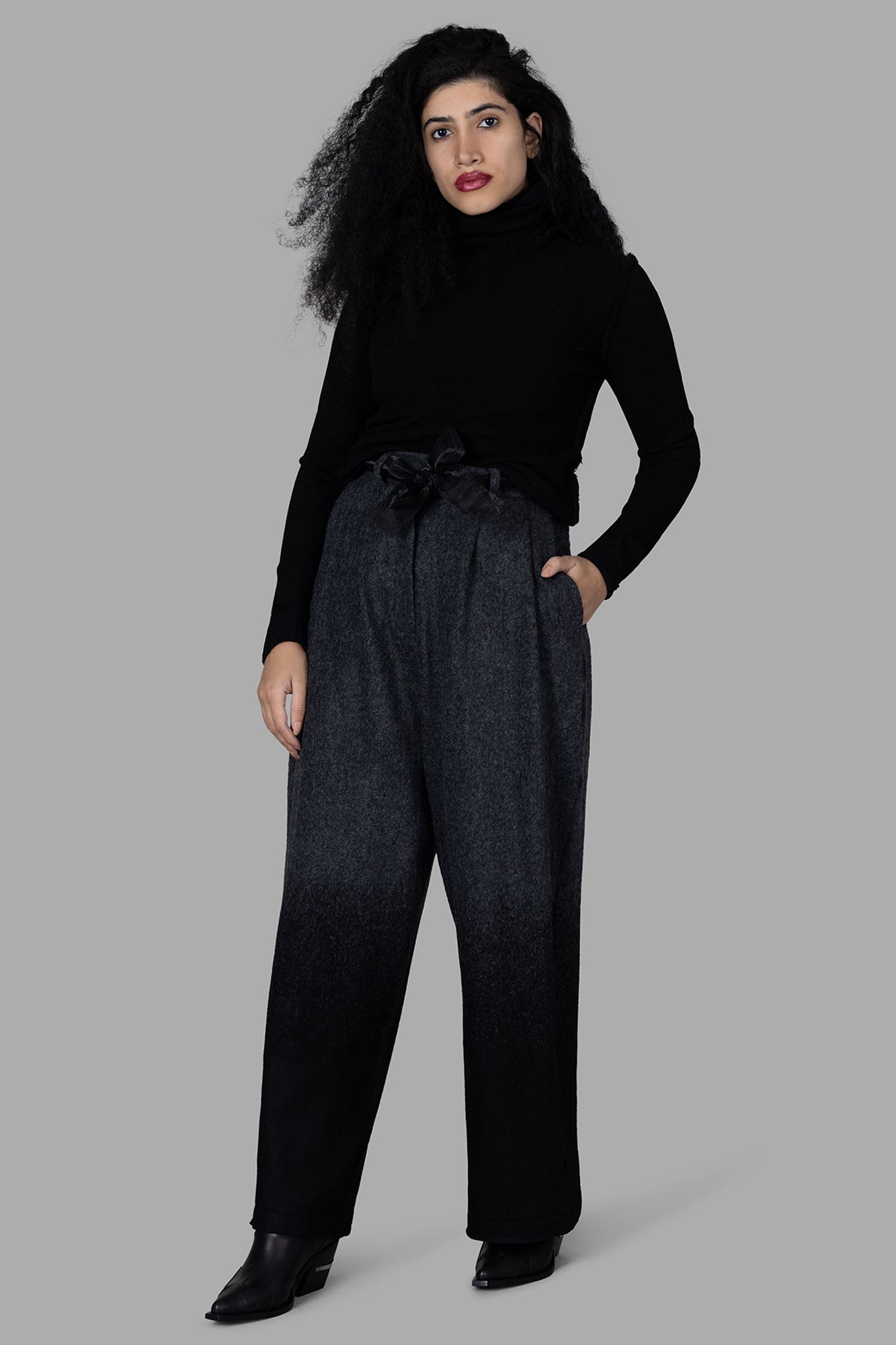 Marc Point black roll-neck sweater on model. Front view showcasing cozy merino wool material, perfect for chilly days.