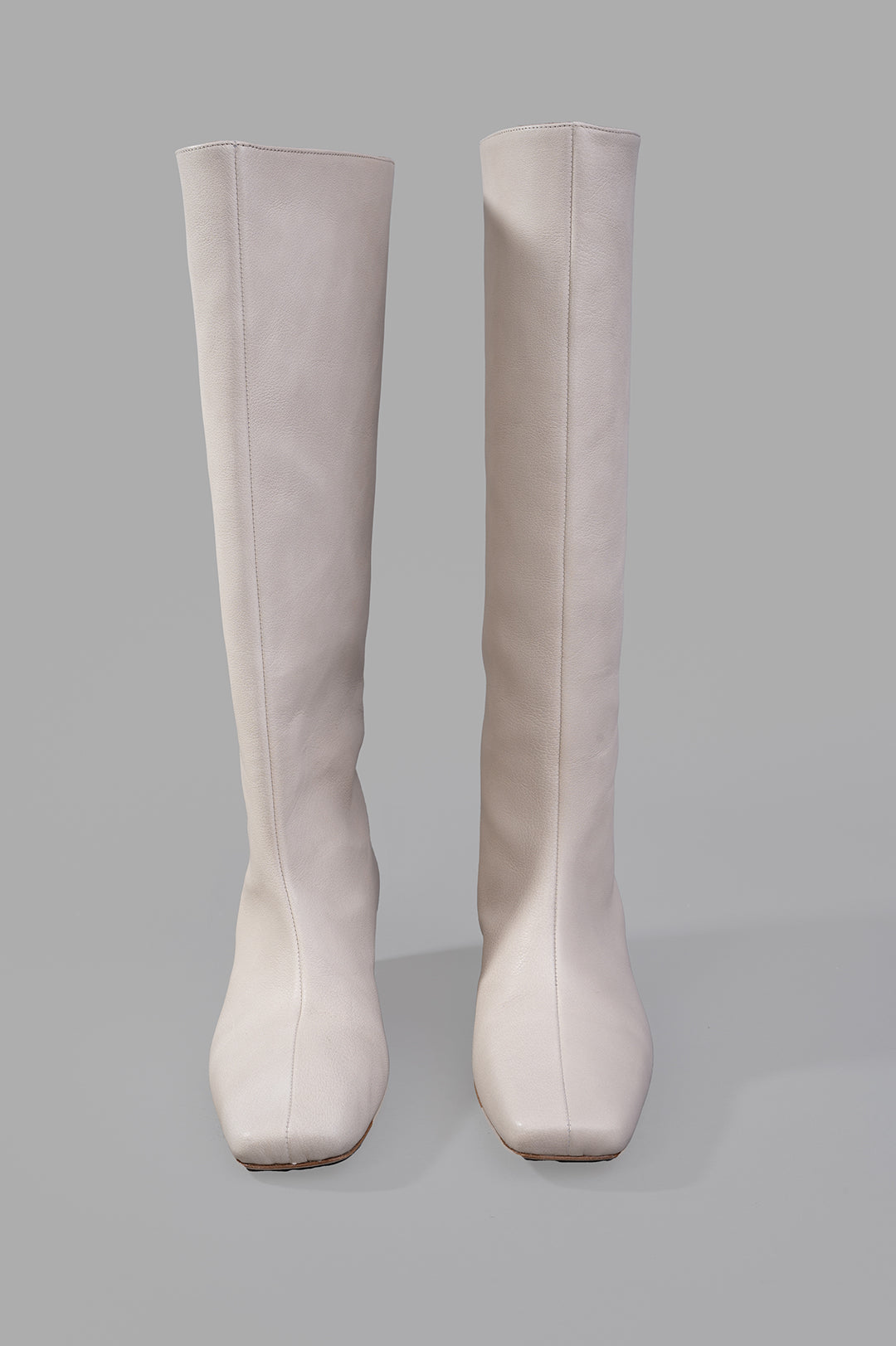 Gentry Portofino Square-toe Boots in ecru, showcasing a sleek tall design with a modern square toe and soft leather texture.