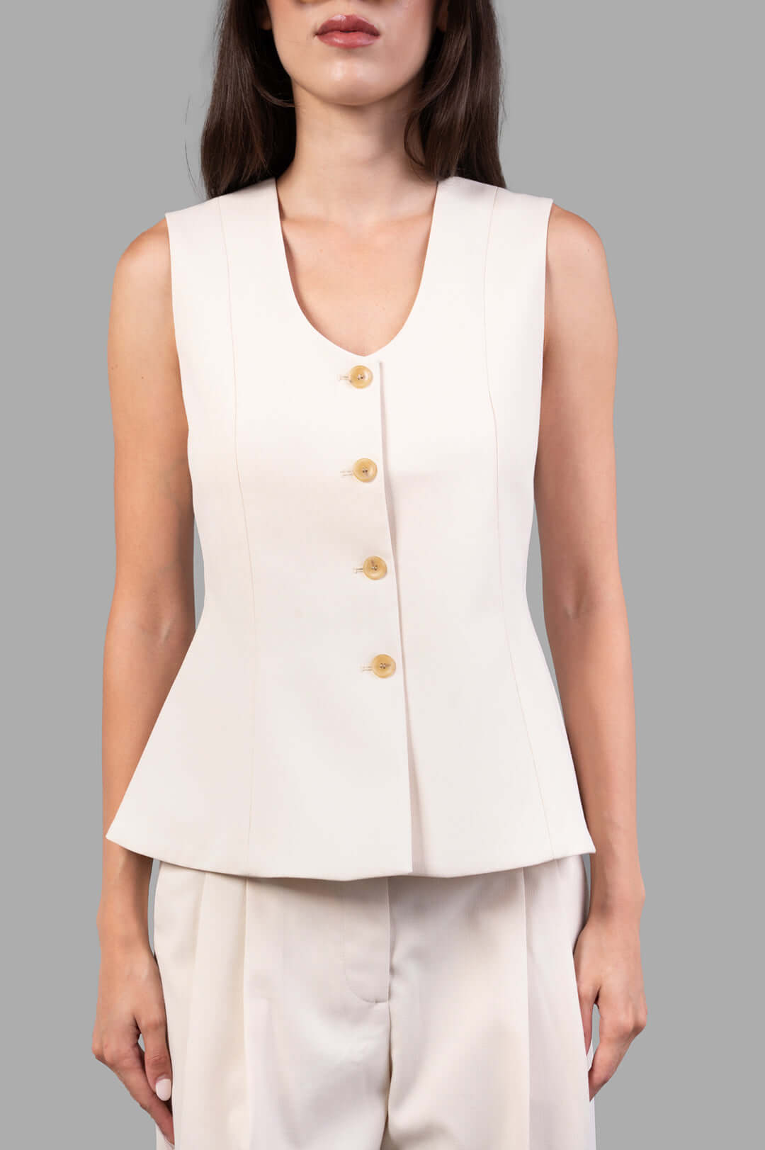 By Malene Birger Merlin Waistcoat in pearl, showcasing a close-up of the deep neckline and button details on a model.