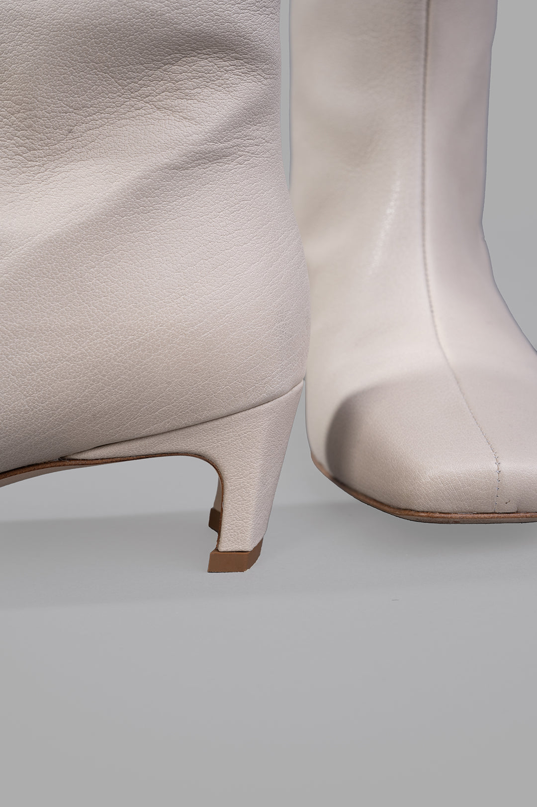 Gentry Portofino Square-toe Boots highlighting the ecru leather texture and stylish heel from a close-up view.