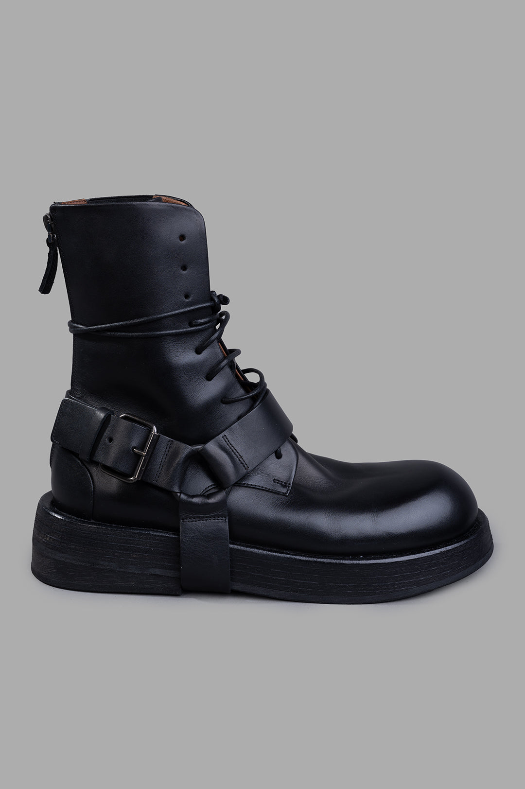 Marsèll Musona Ankle Boots in black leather, side view featuring strap details and hefty sole.