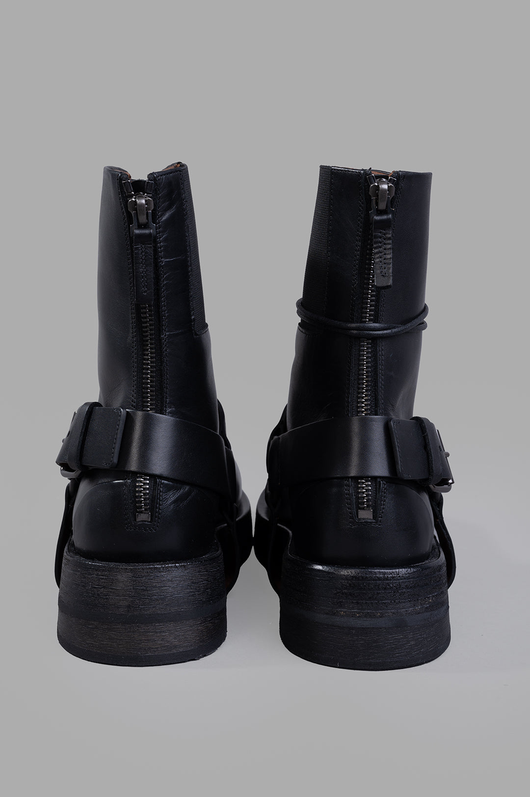 Marsèll Musona Ankle Boots featuring a bold leather design, back view with zippers and straps, resting on a sturdy sole.