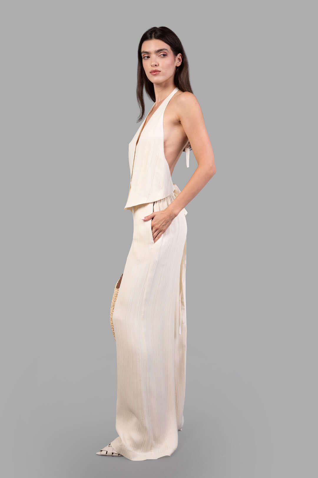 Joseph Suez Pleat Jacquard Tie Waistcoat, halter neck with linear texture, shown in profile on model.