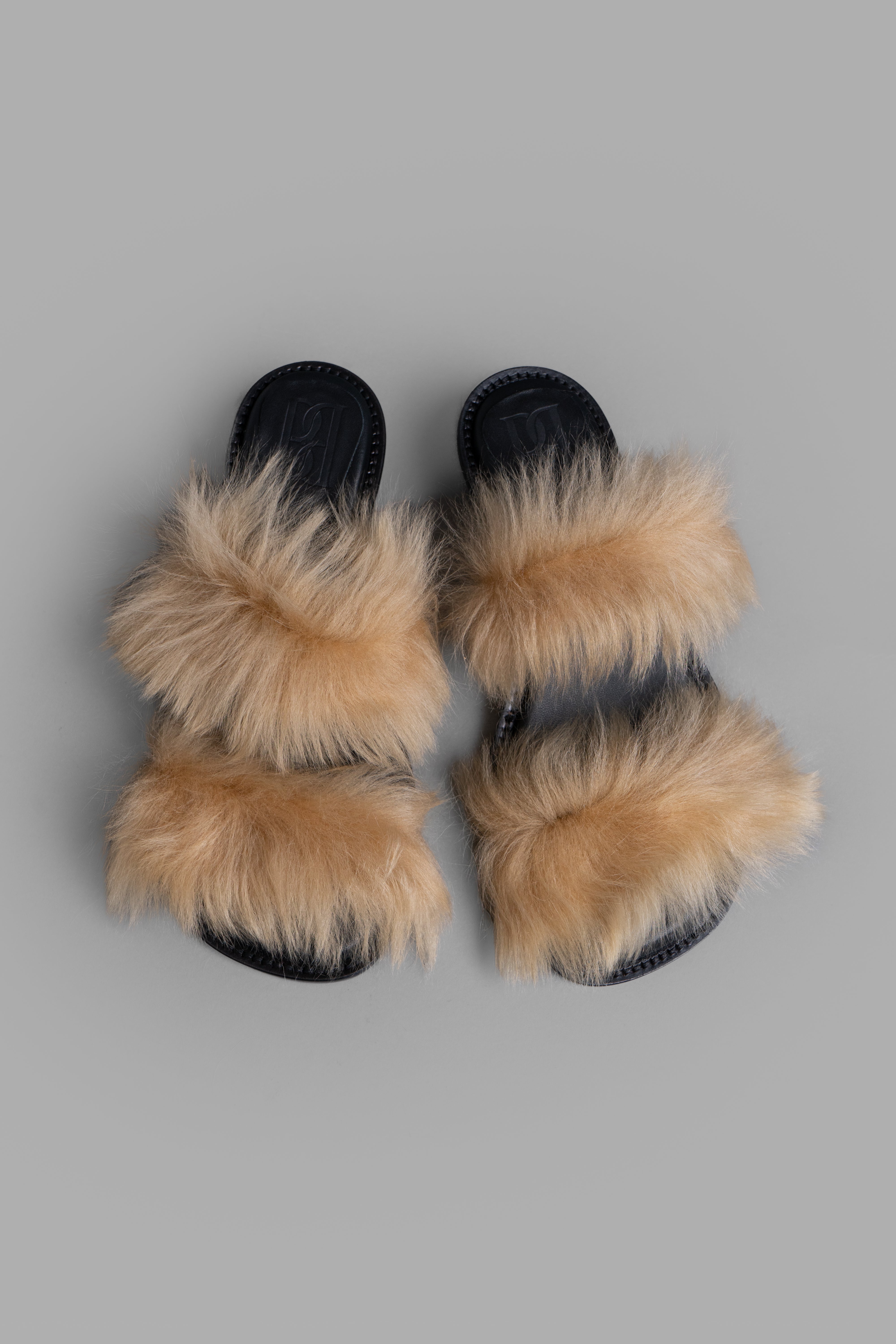 By Malene Birger Tianna Sandals feature a soft shearling upper with a low Cuban heel, ideal for year-round comfort.