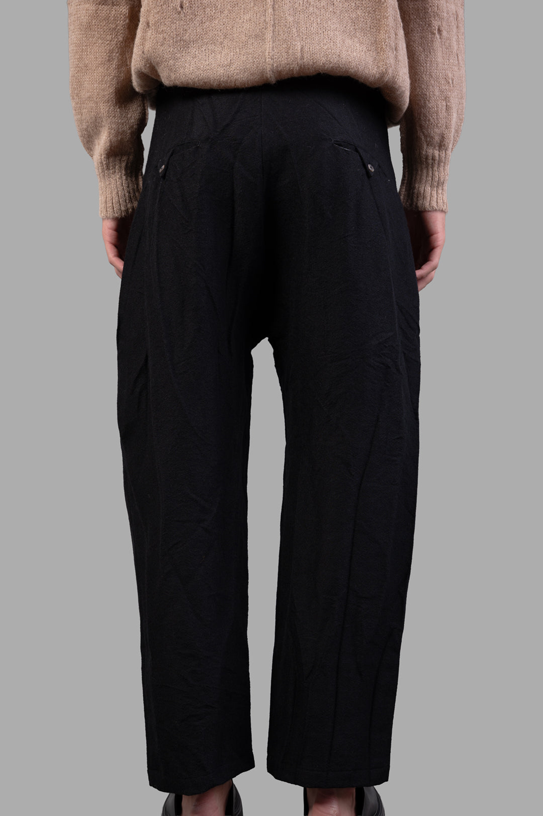 Marc Point. Wool Trousers in black, showcasing pleats and high waist from a back view, cropped for modern style and comfort.