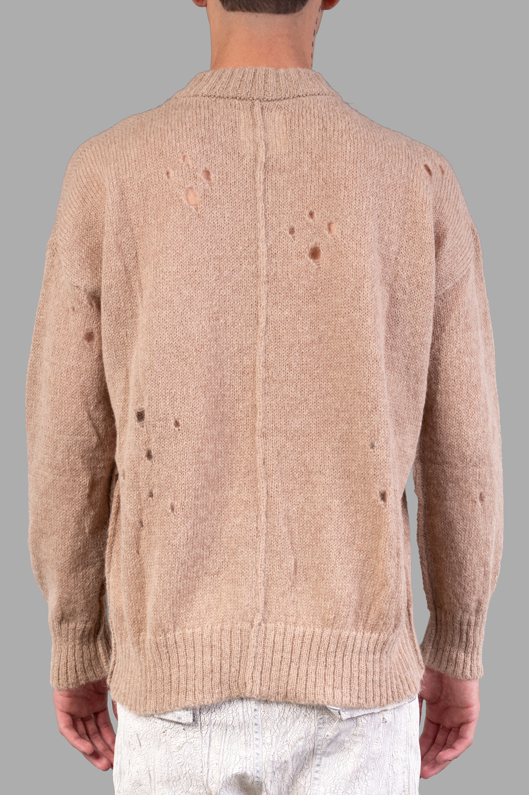 Marc Point Beige Sweater, shown from the back, featuring distressed detailing and a cozy knit texture.