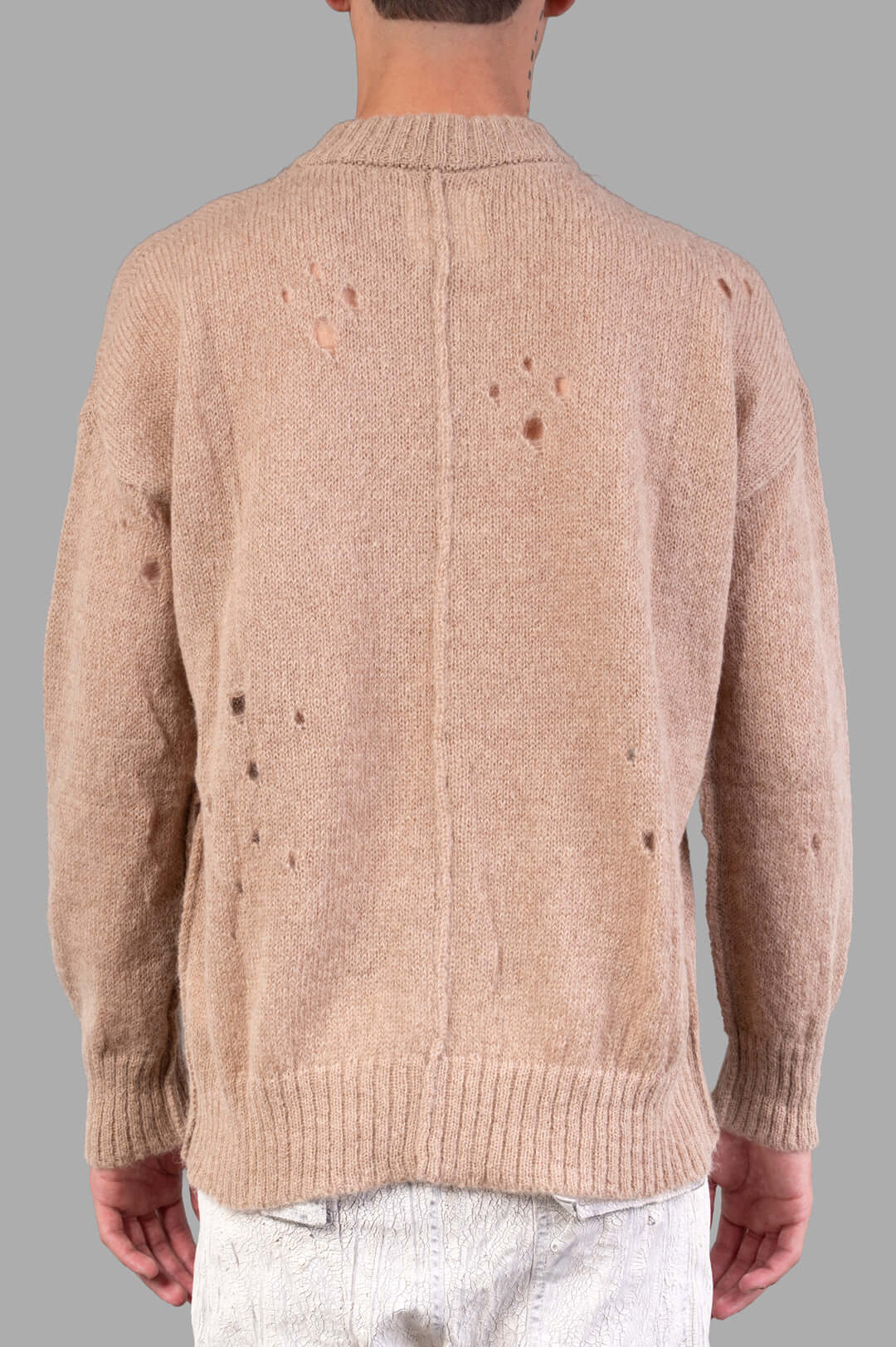 Marc Point Beige Sweater, shown from the back, featuring distressed detailing and a cozy knit texture.