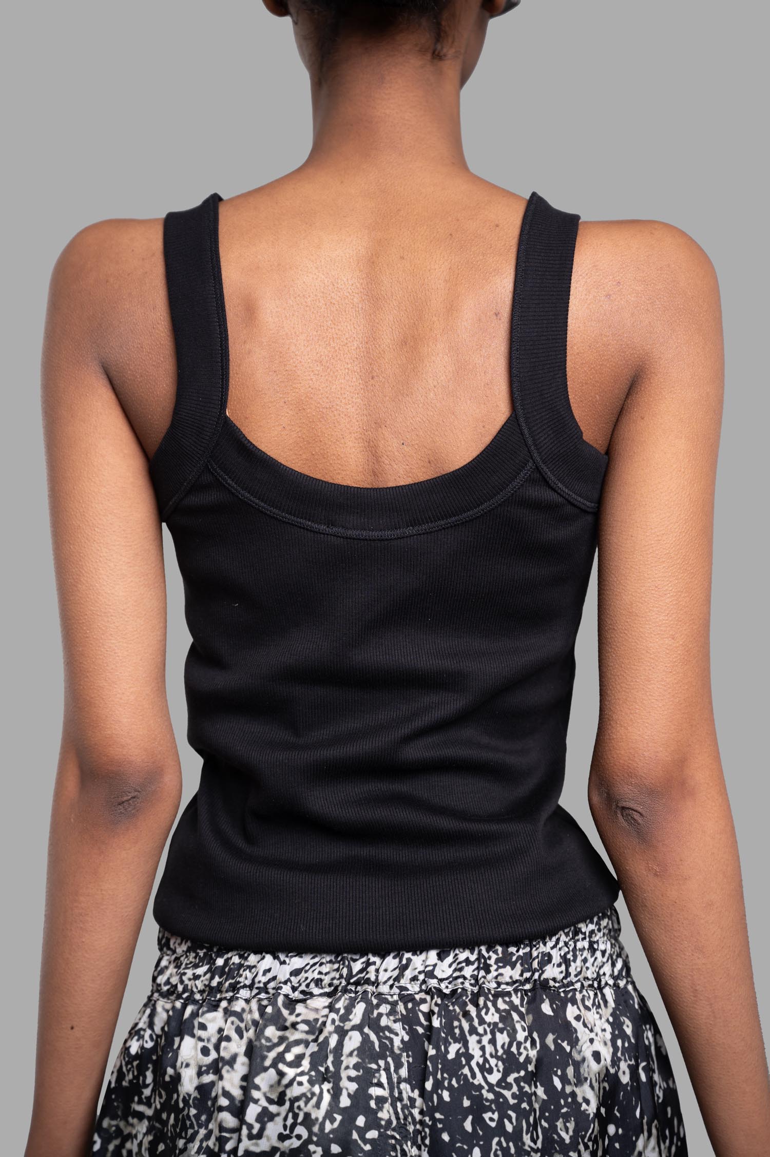 By Malene Birger Frillio Top displayed from the back, featuring a low round neckline and wide straps in black organic cotton.