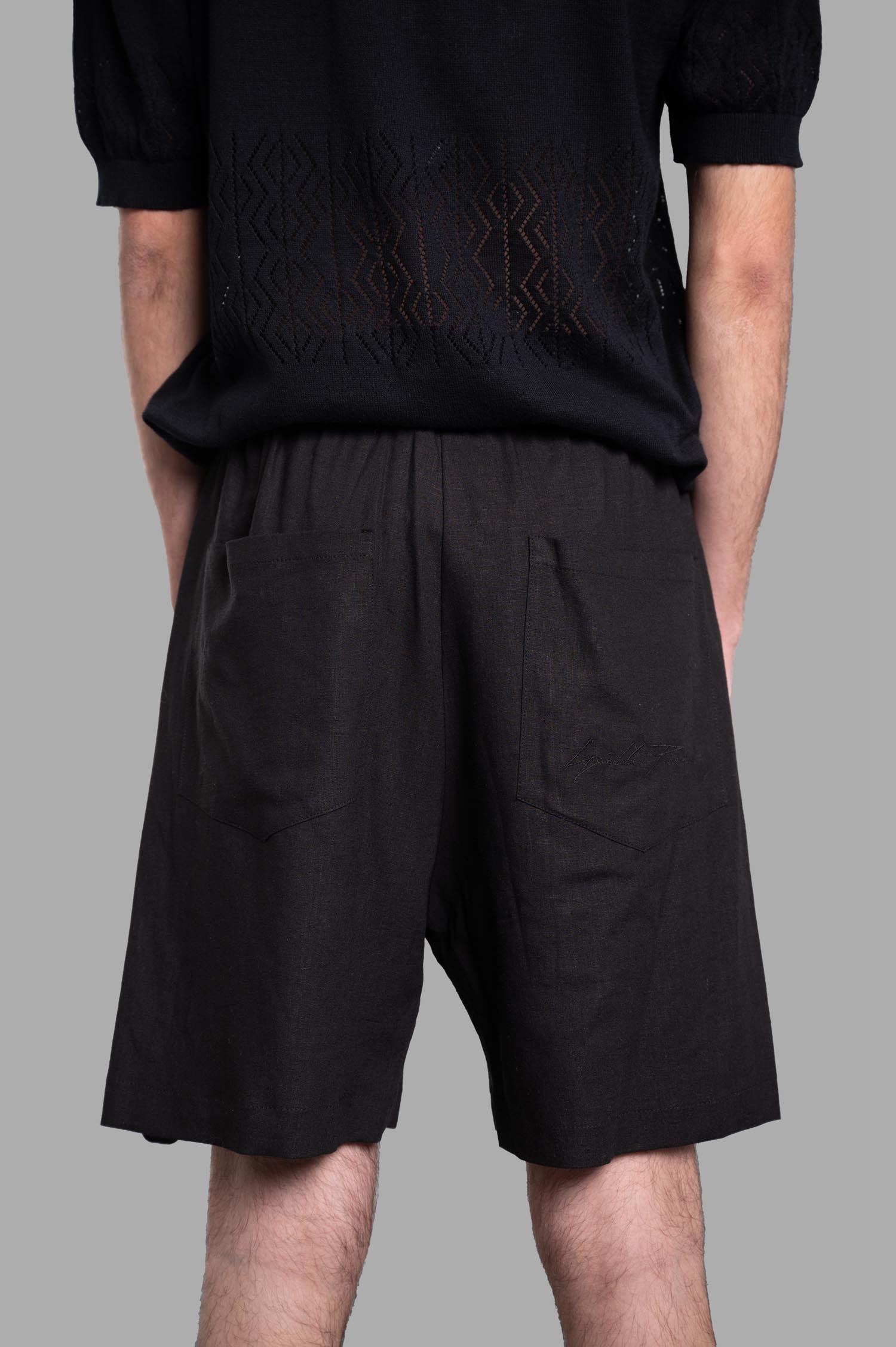Gaëlle Paris Bermuda Shorts shown from the back, highlighting the pockets and elastic waistband detail.