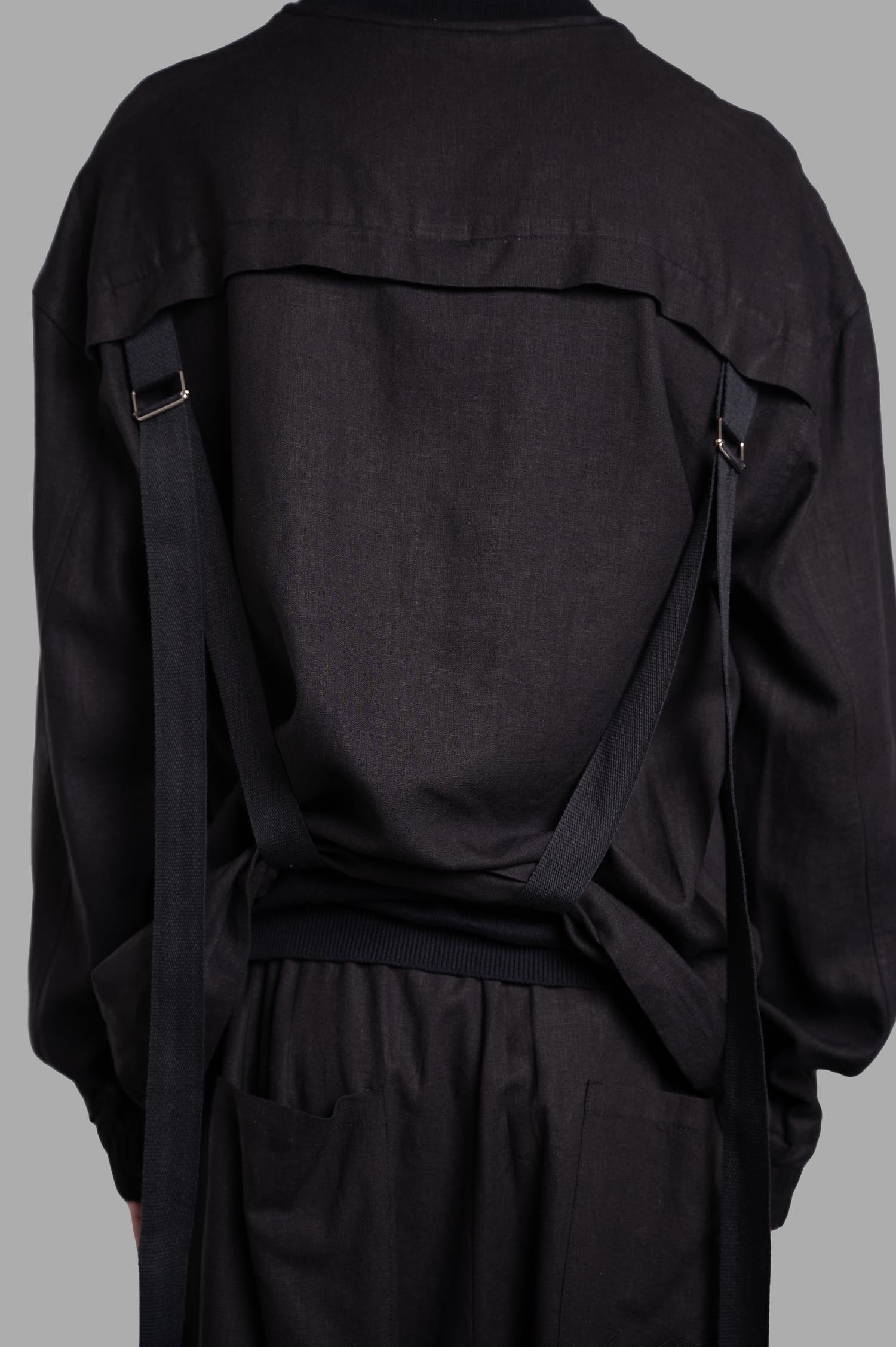 Gaëlle Paris Drawstring Jacket featuring back drawstrings and textured black fabric, styled from the back.