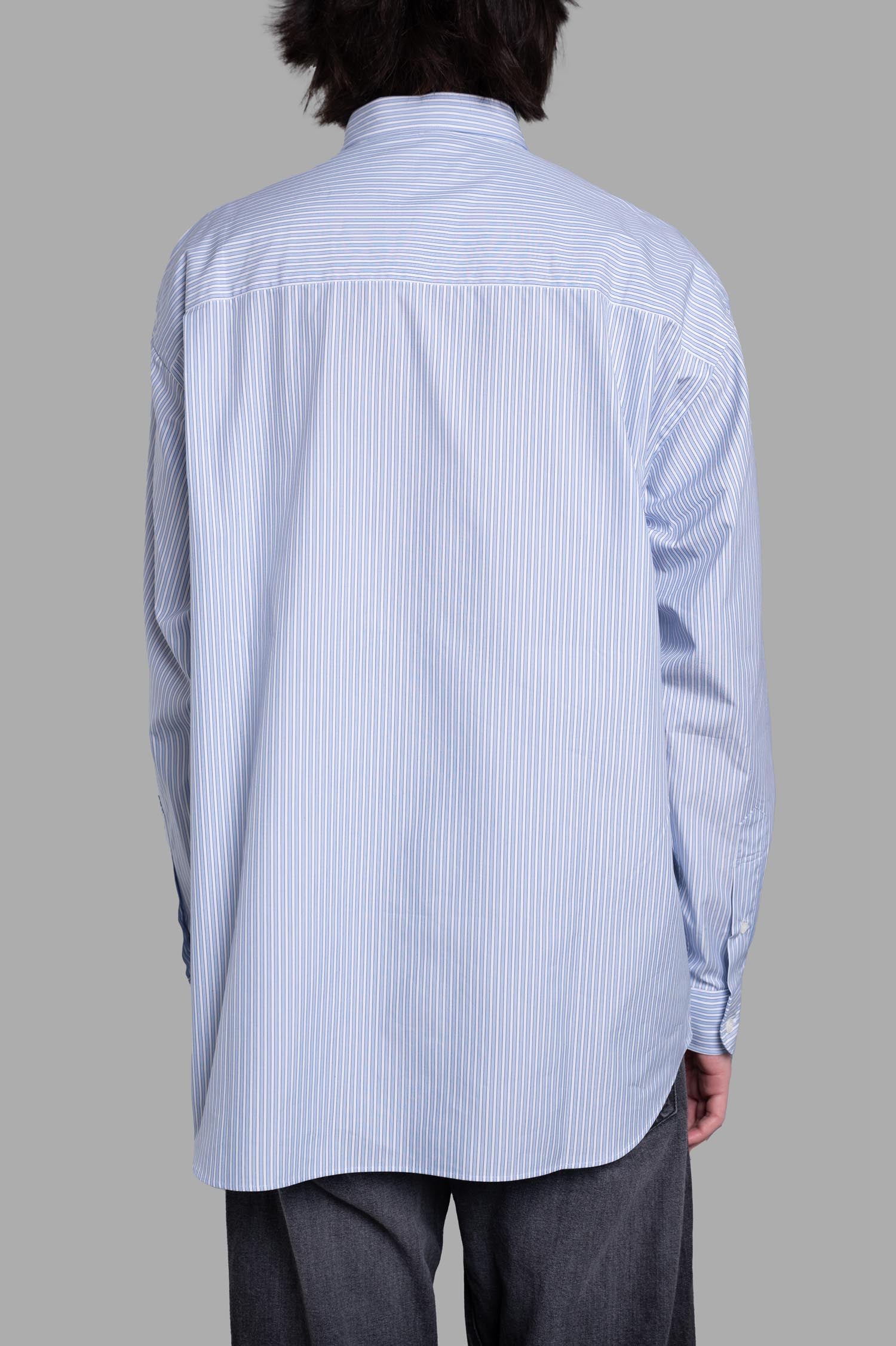 Comme des Garçons Striped Poplin Shirt shows the back view with fine blue pinstripes and precise tailoring details.