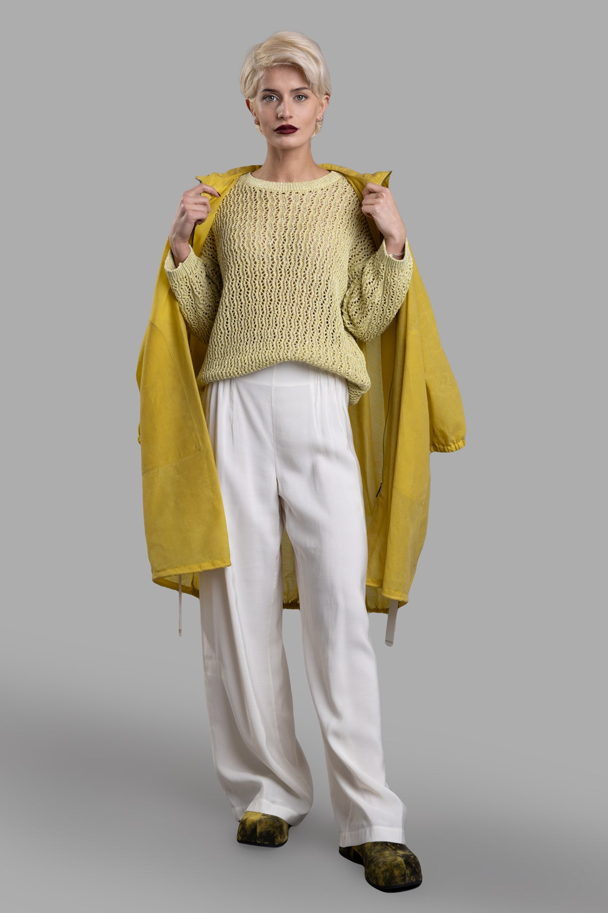 Gentry Portofino lime sweater on model, showing front view with round neck design and stylish dropped shoulders.