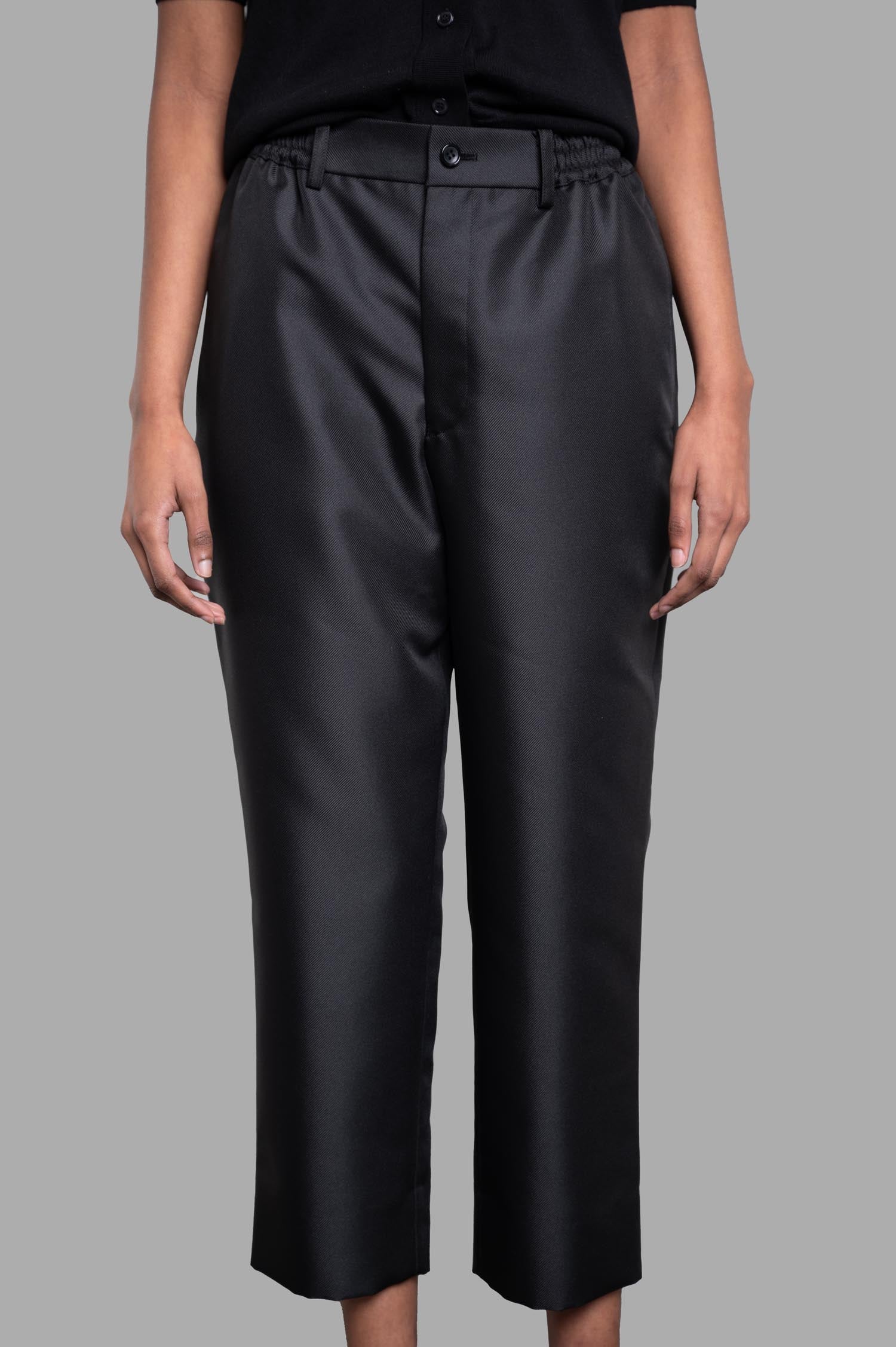 Comme des Garçons Cropped Trousers in black, showcasing elastic waistband, straight legs, and side pockets.