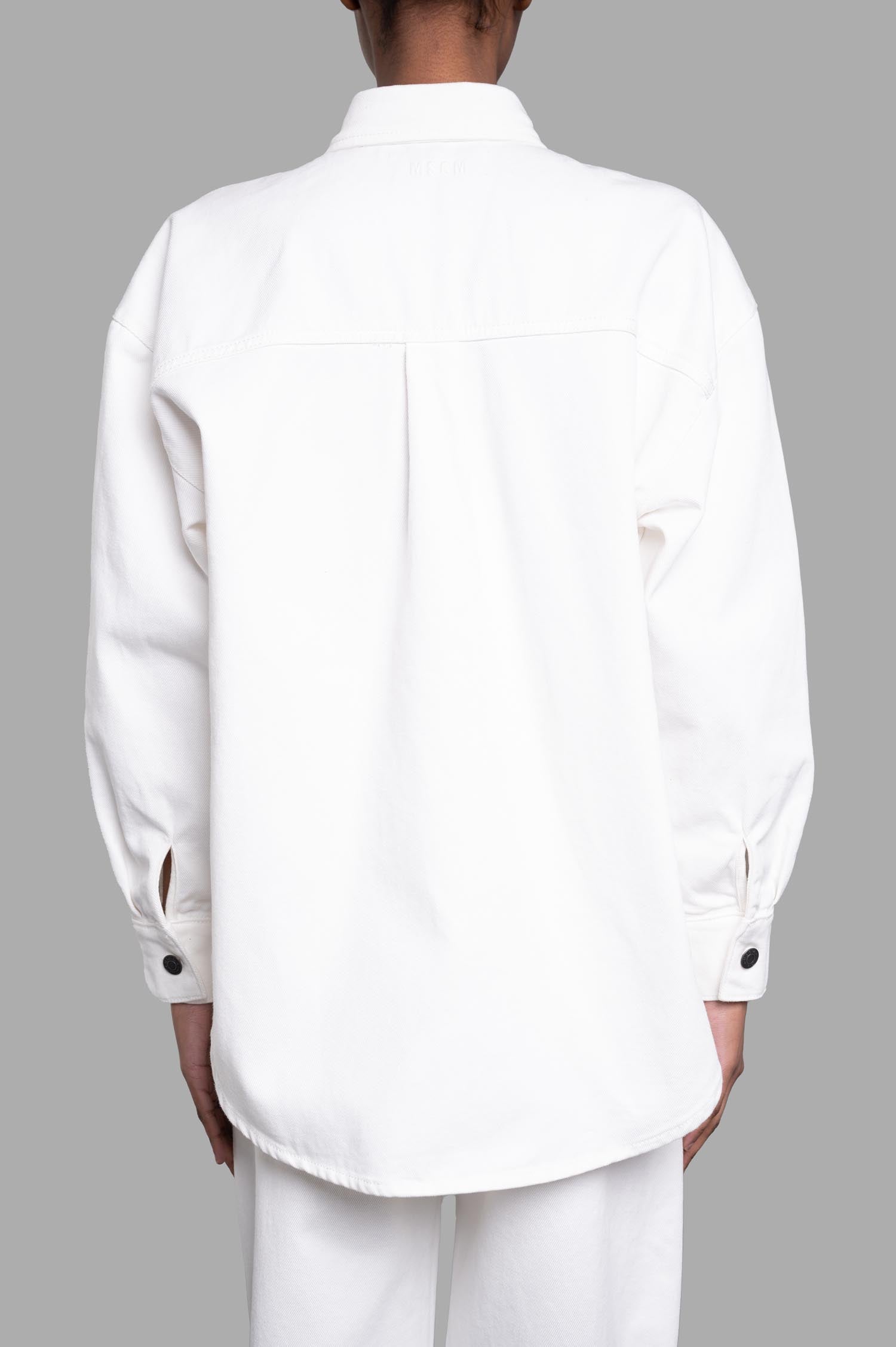 MSGM Denim Shirt with Raffia Flowers showcases a stylish back view, featuring long sleeves and button details in white cotton.