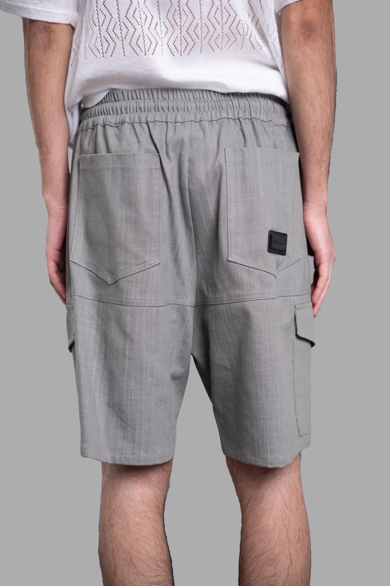 Gaëlle Paris. Drawstring Bermudas in Grey, showcasing back view with elasticized waist and cargo-style pockets.
