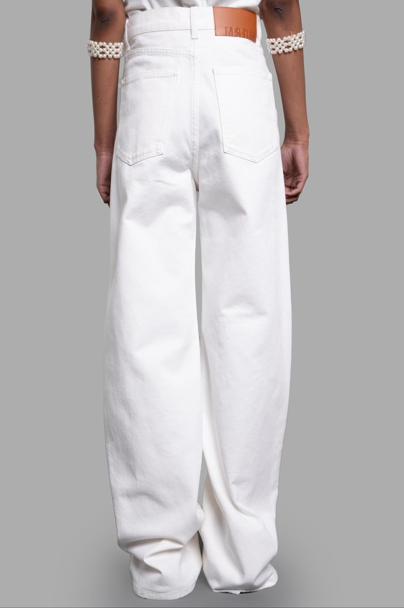 MSGM Denim Trousers with Raffia Flowers, rear view showcasing the well-crafted pockets and soft cotton texture.