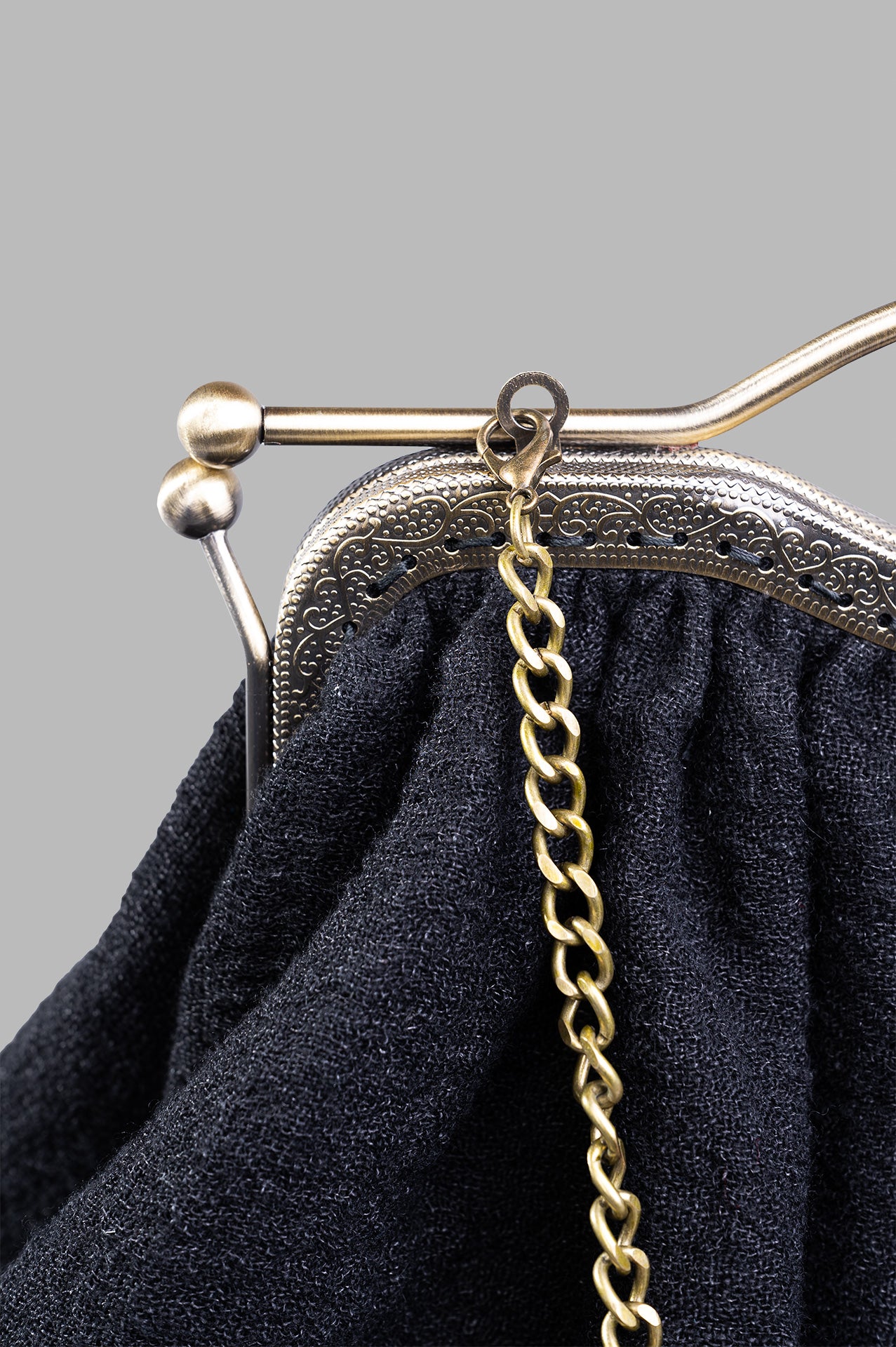 Marc Point. Close-up of Oversized Vintage-style Bag showcasing textured black fabric and ornate gold chain strap detail.