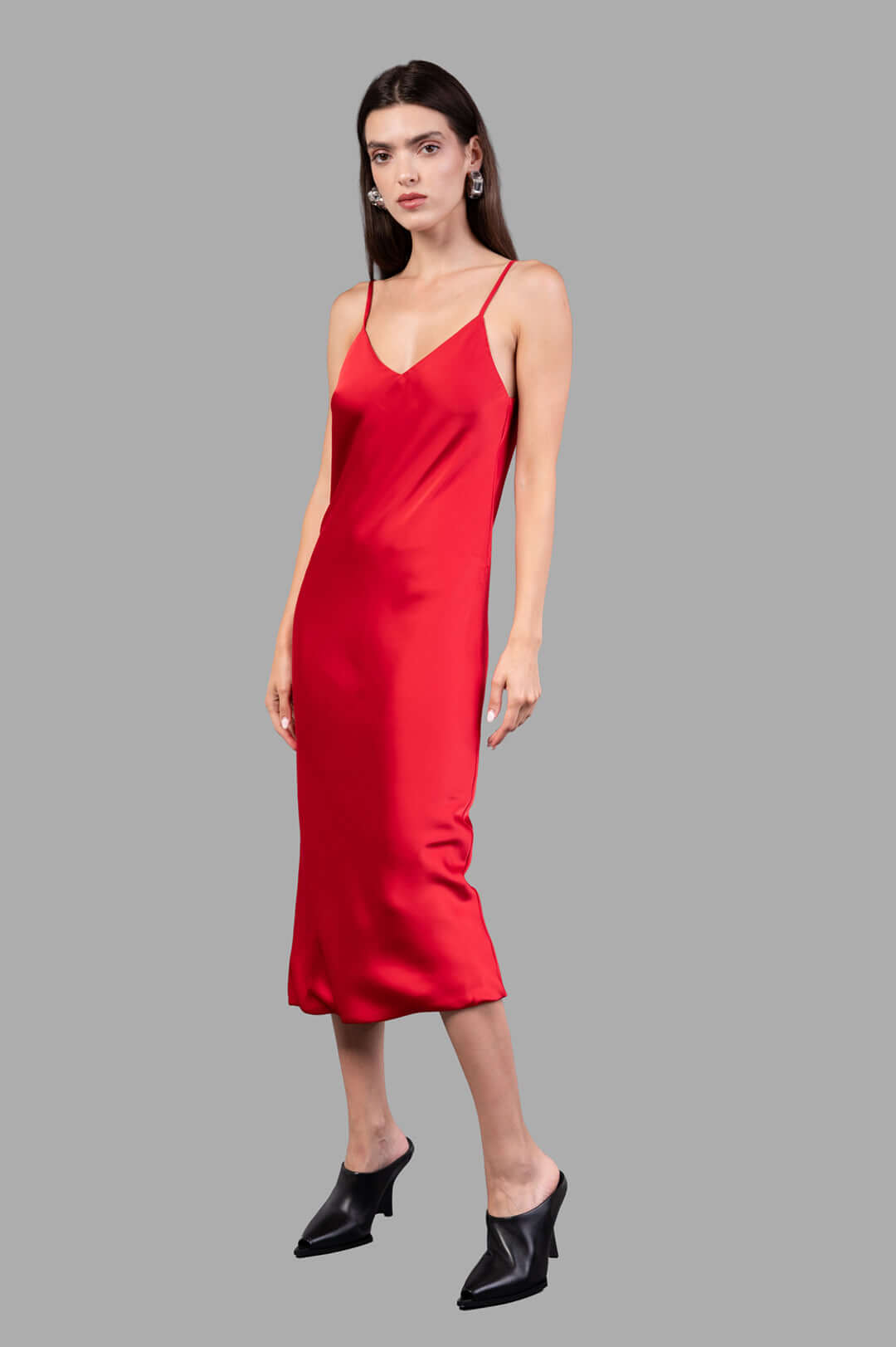 Norma Kamali Bias Slip Dress in red, front view on model, featuring a sleek silhouette with thin straps.
