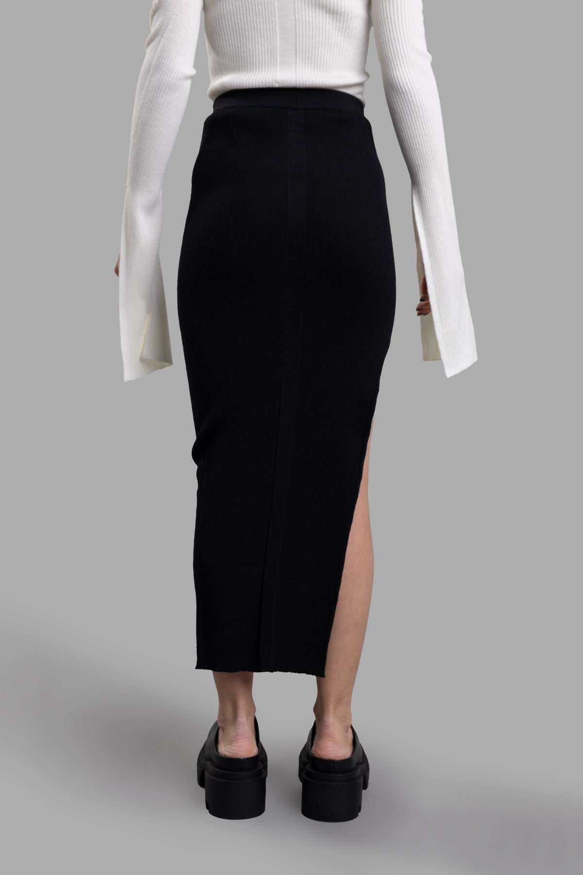 Rick Owens Ziggy Skirt in black, featuring a tapered design, knit waistband, and a side split above the knee, seen from the.