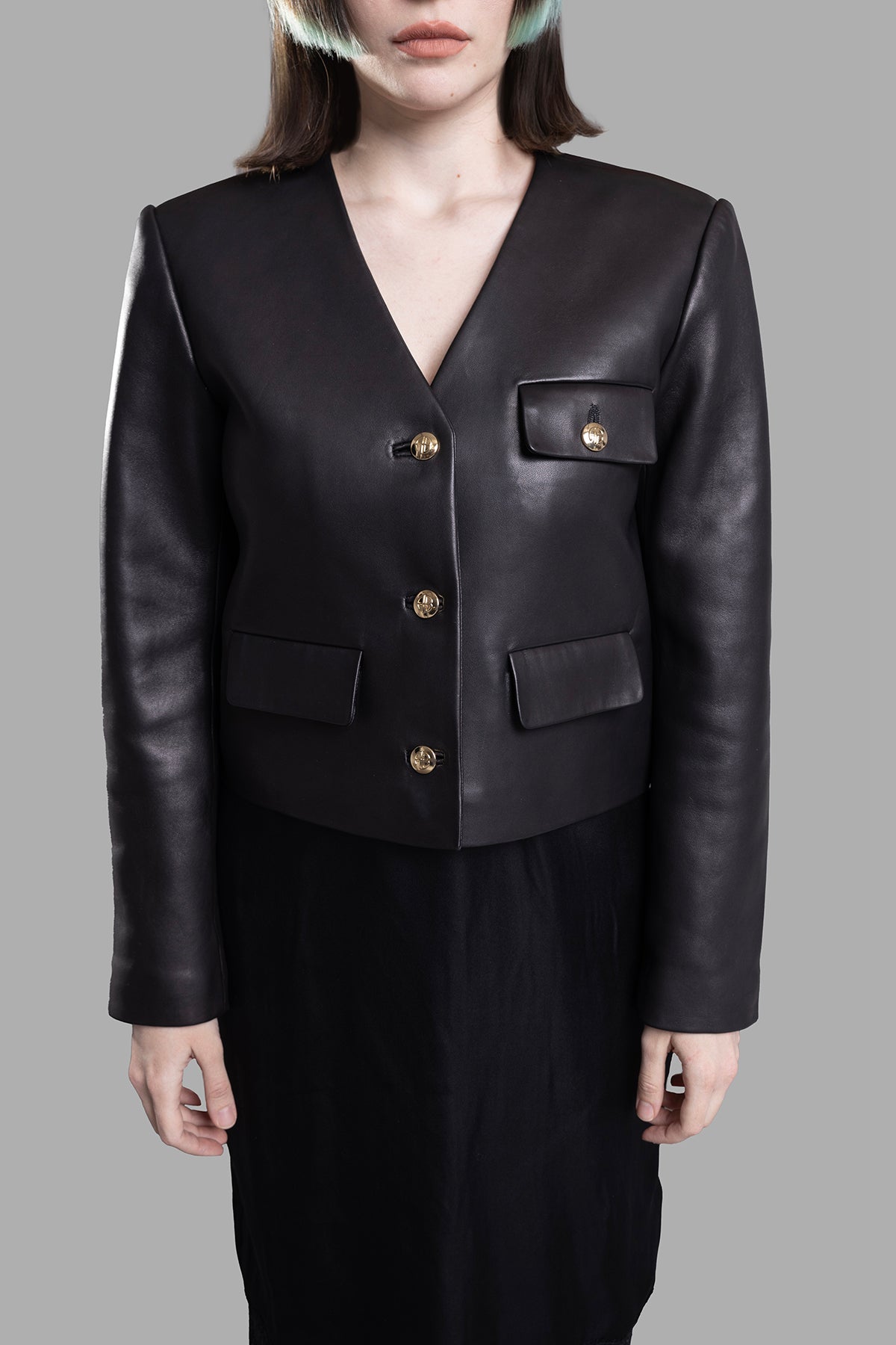 Anine Bing Cara Collarless Jacket featuring a sleek design with gold buttons and front pockets, shown on a model.