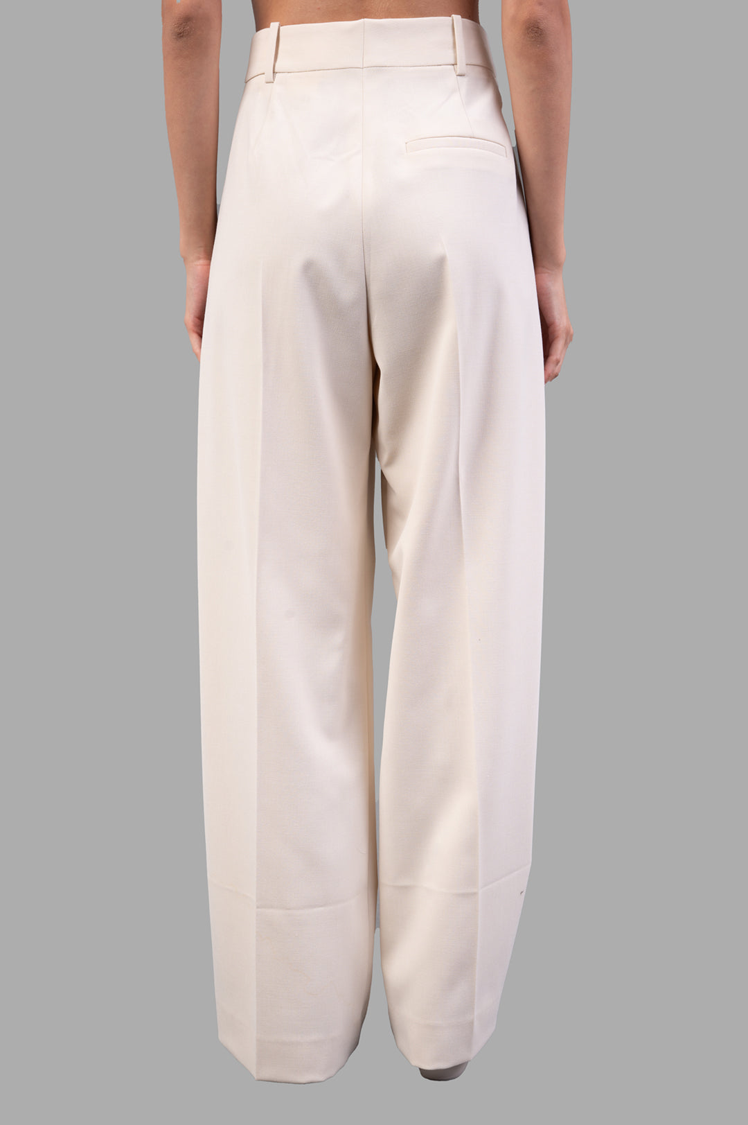 By Malene Birger Cymbaria High-waist Trousers in Pearl, showcasing pleats and wide legs from the back view.