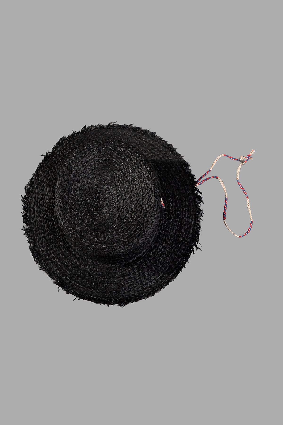 Kijima Takayuki Black Straw Boater Hat viewed from above, showcasing its textured weave and colorful adjustable strap.