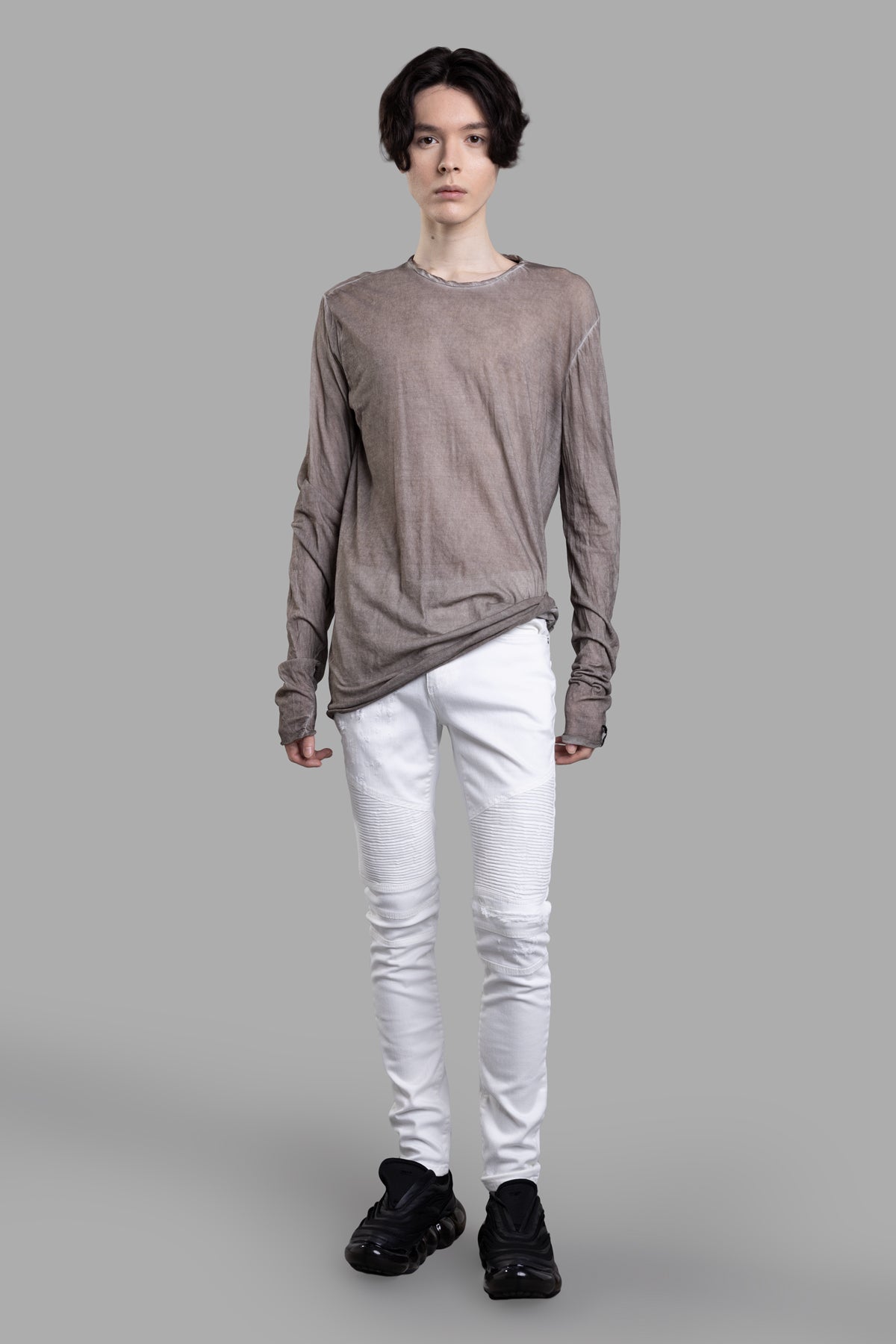 MD 75 Taupe Blouse on model, front view. Long-sleeved, round neck, semi-sheer cotton, off-center back seam.