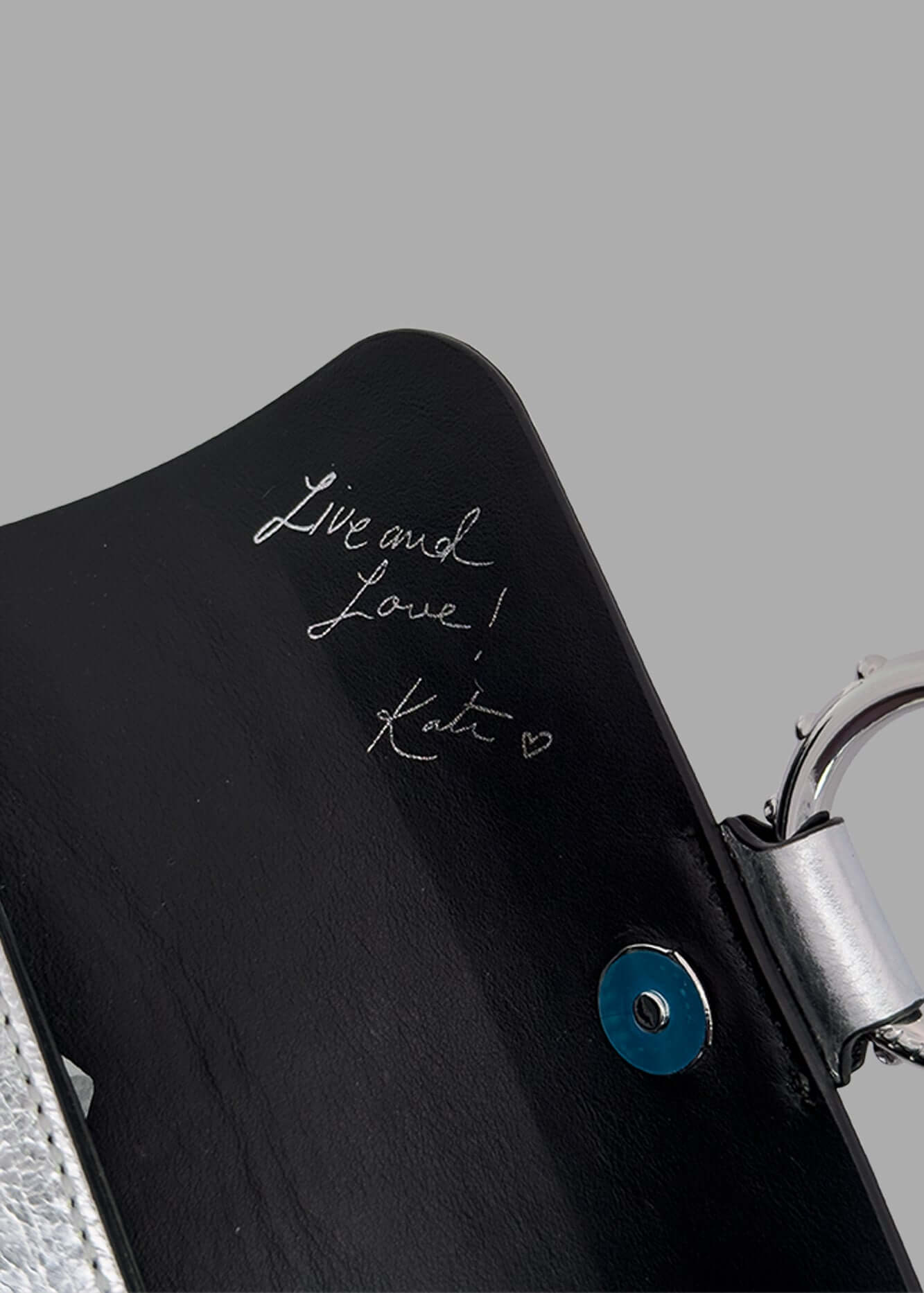 Zadig & Voltaire Kate Mini Bag detail view showcasing embossed signature and silver-tone hardware in sleek black leather.
