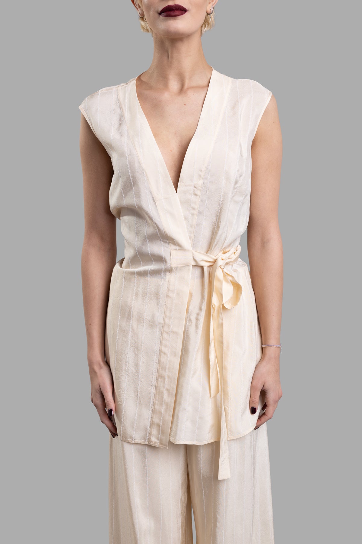 Gentry Portofino Wrap-me-up Top in ecru, featuring a V-neckline, side bow, and hip-length design, displayed on a model.