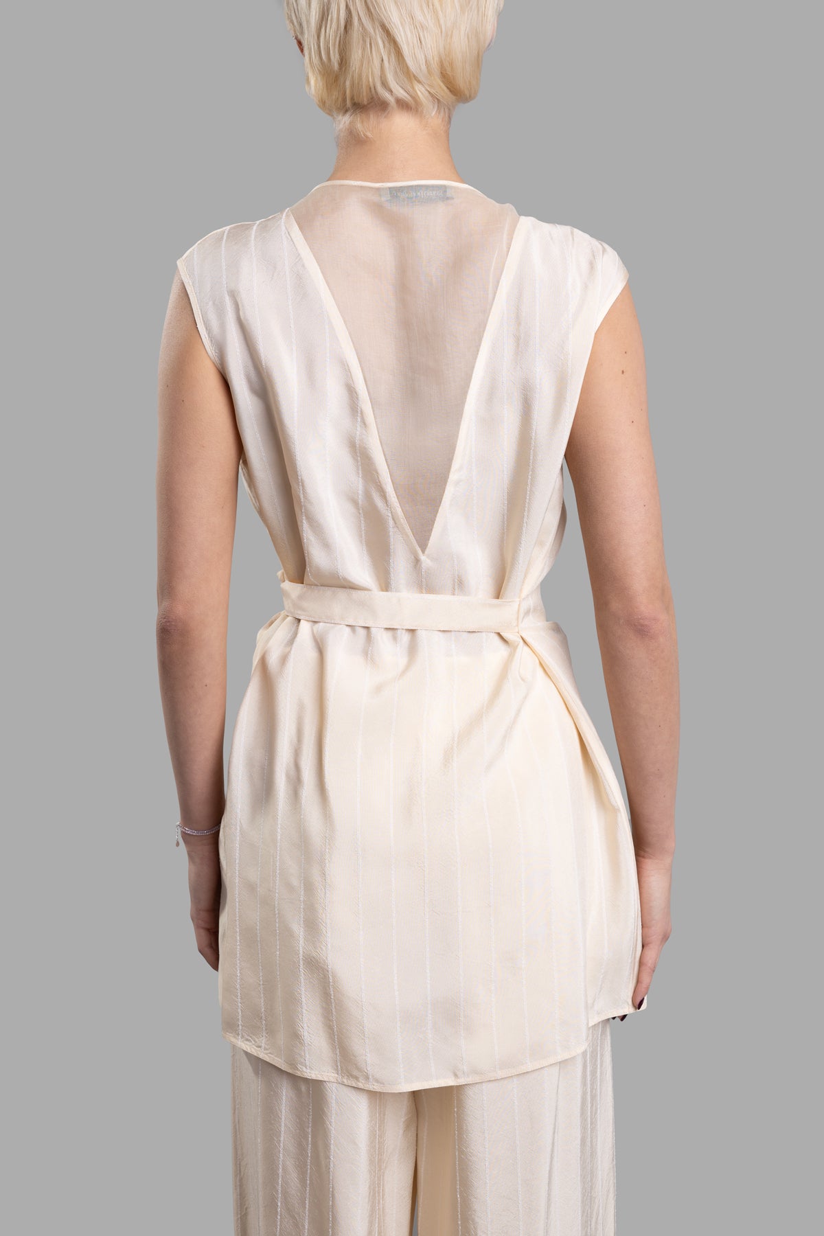 Gentry Portofino Wrap-me-up Top showcased from the back, featuring a V-neckline and elegant side bow detail in ecru.