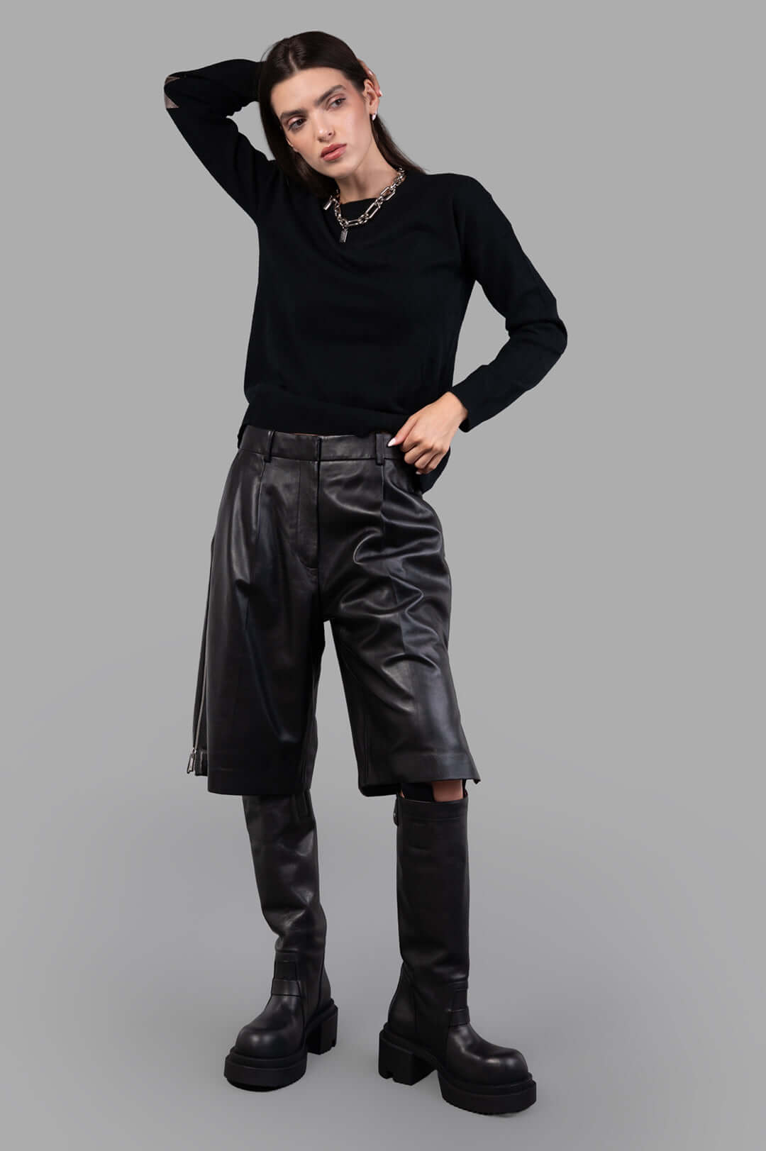 Helmut Lang black Leather Zoot Shorts, wide-leg, knee-length, shown on-model with adjustable side slit zippers.