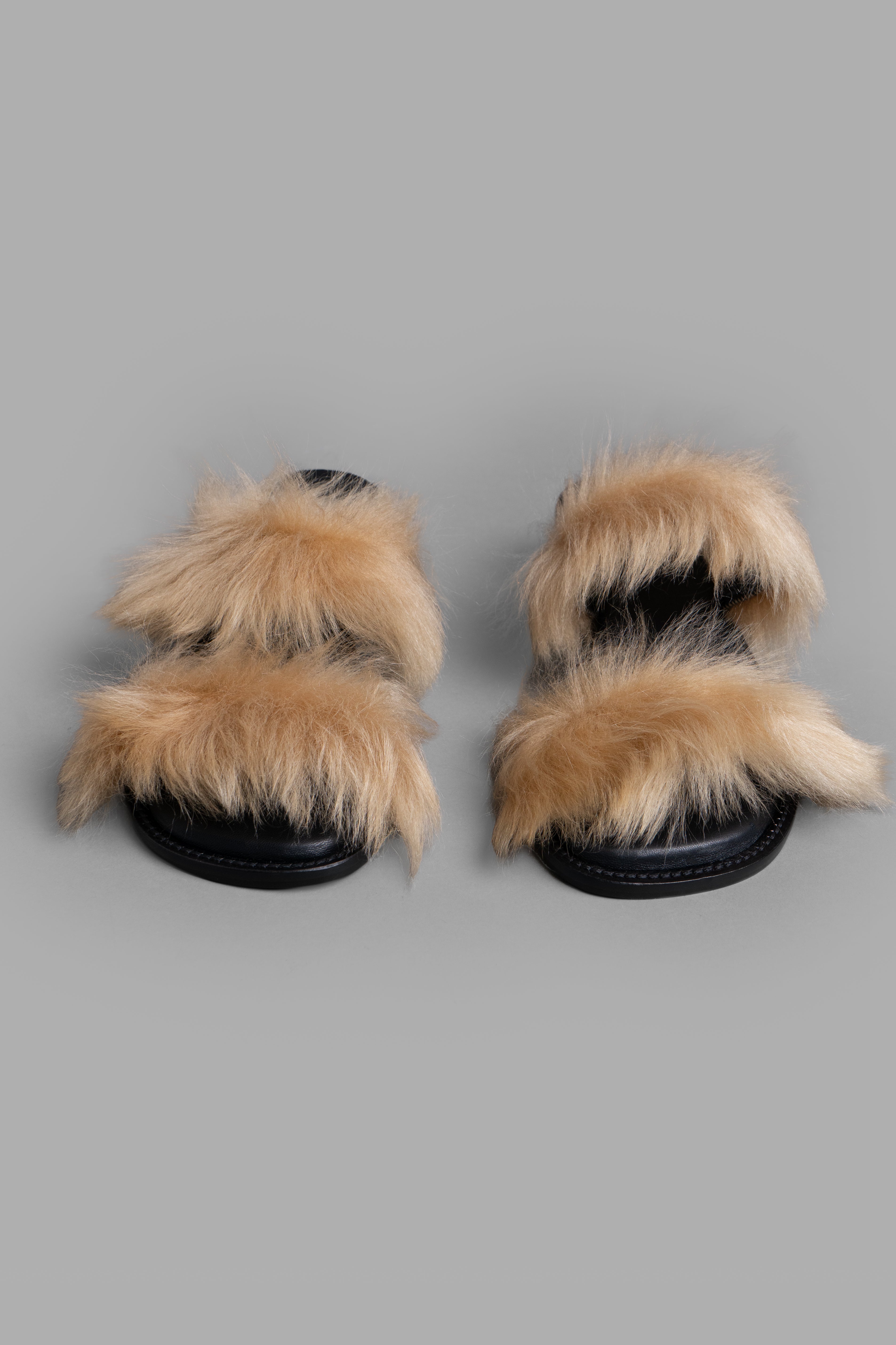 By Malene Birger Tianna Sandals in black and beige, showcasing soft cow leather with a textured shearling finish.