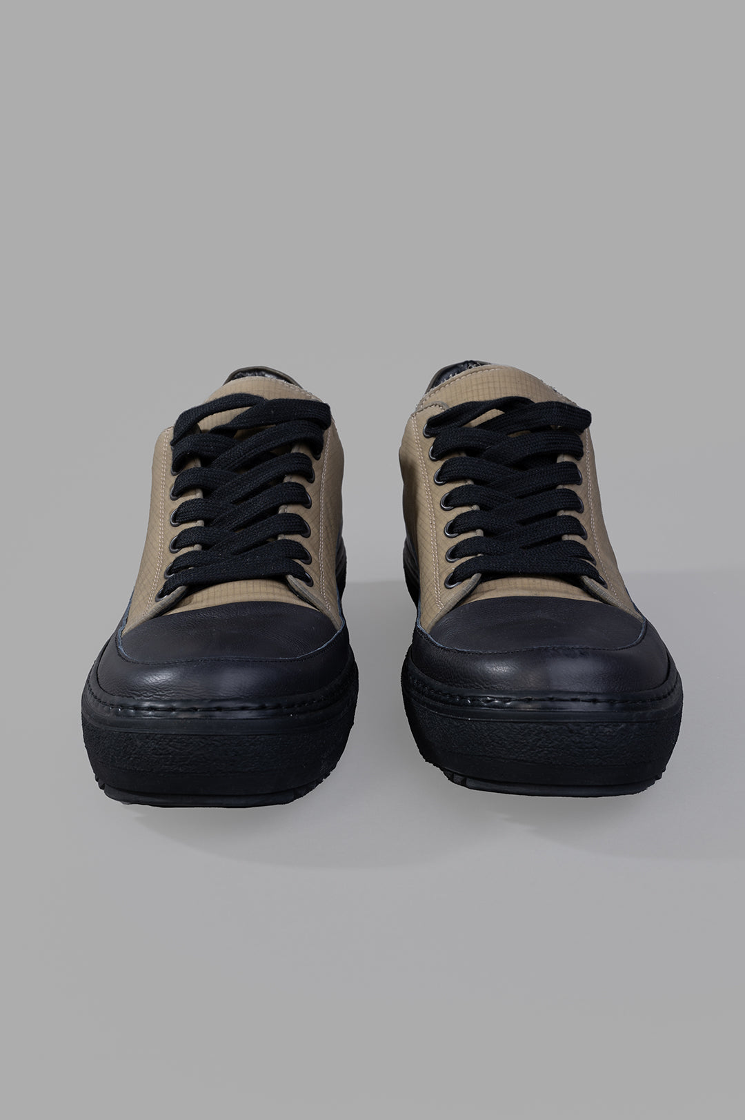 Masnada Low-top Sneakers featuring contrasting nose and laces, showcasing quality cotton and rubber materials in a front.