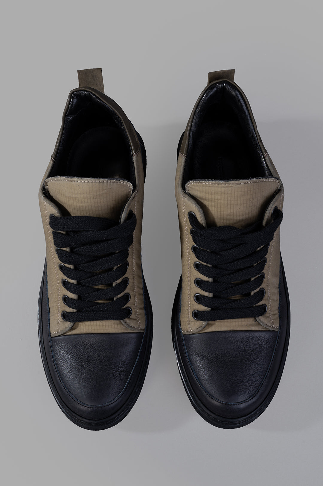 Masnada Low-top Sneakers showcasing a top view, featuring contrasting black laces and a stylish dual-material design.
