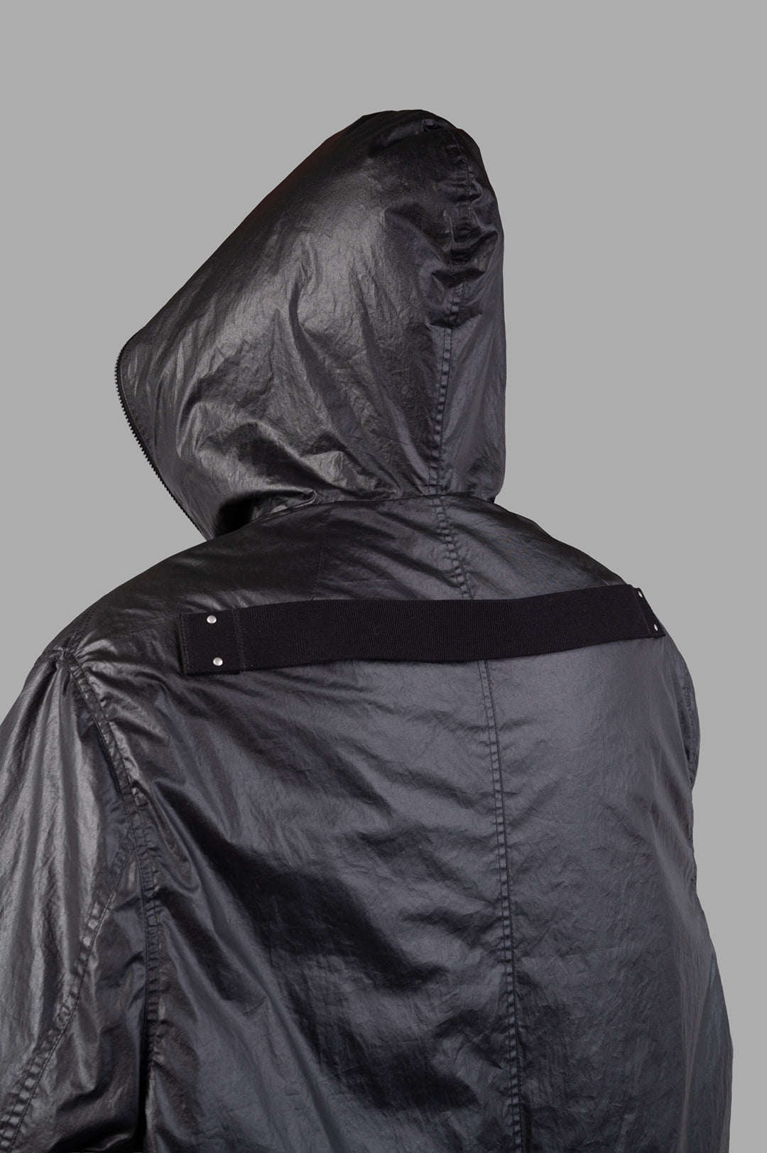Rick Owens Concordians Gimp Mac in Black, showcasing a large hood and unique back strap detail. Stylish below-knee length.