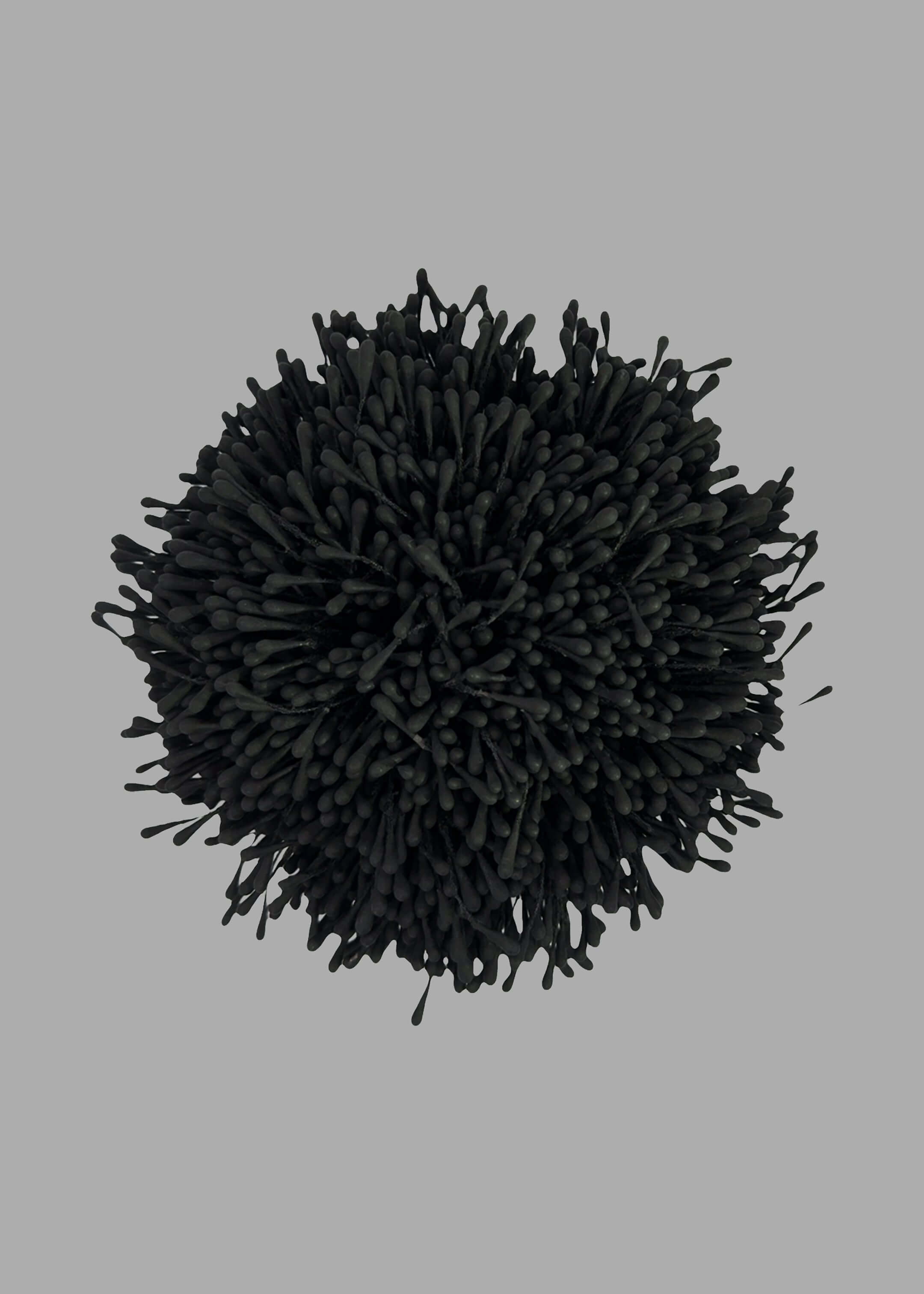 By Malene Birger Henna Brooch in Black, top view. Anemone-inspired design, polyester texture. Elegant accessory piece.