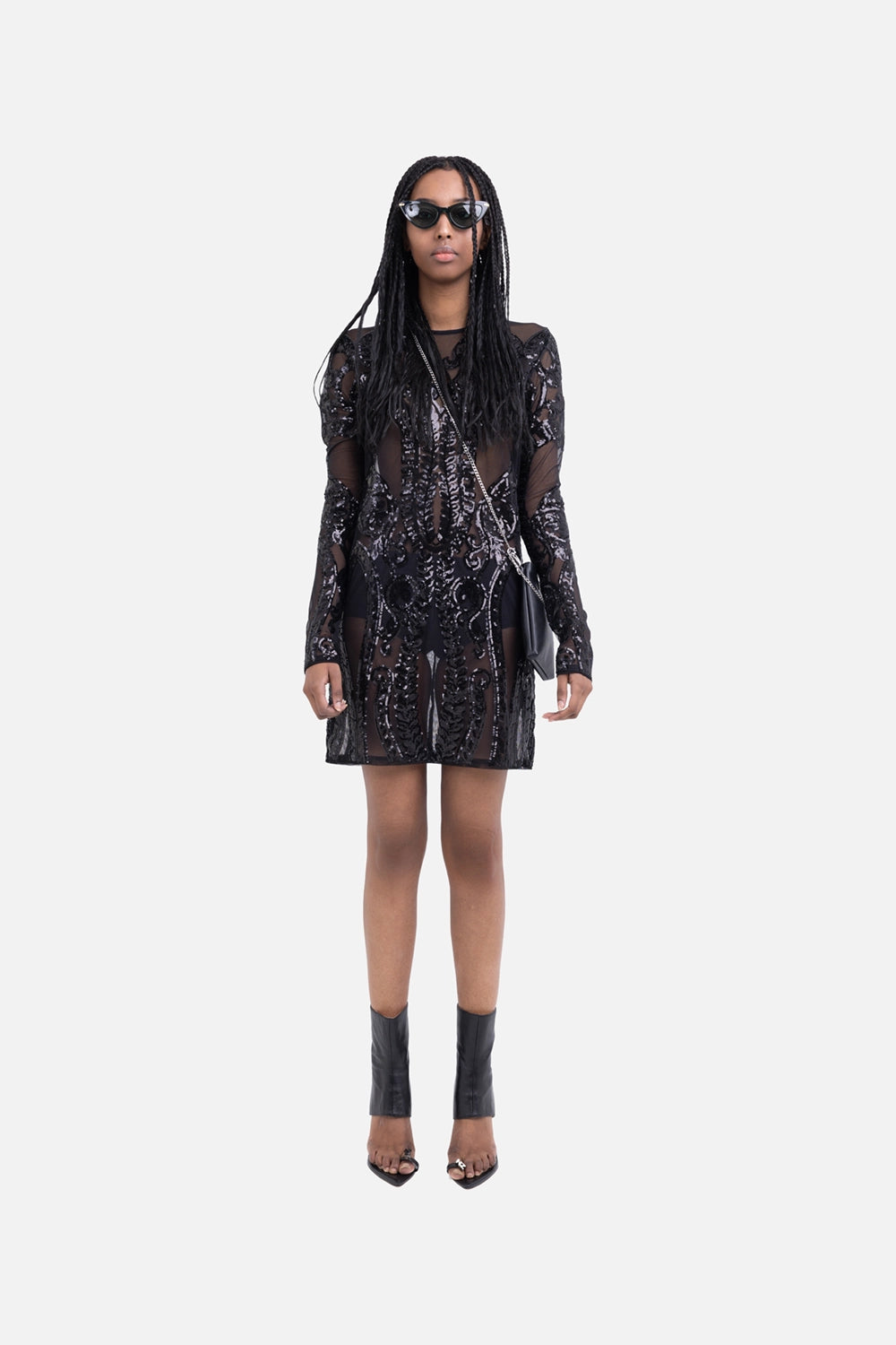 Norma Kamali women's mini dress in black, on-model full-length, fitted long sleeves with semi-sheer sequin mesh