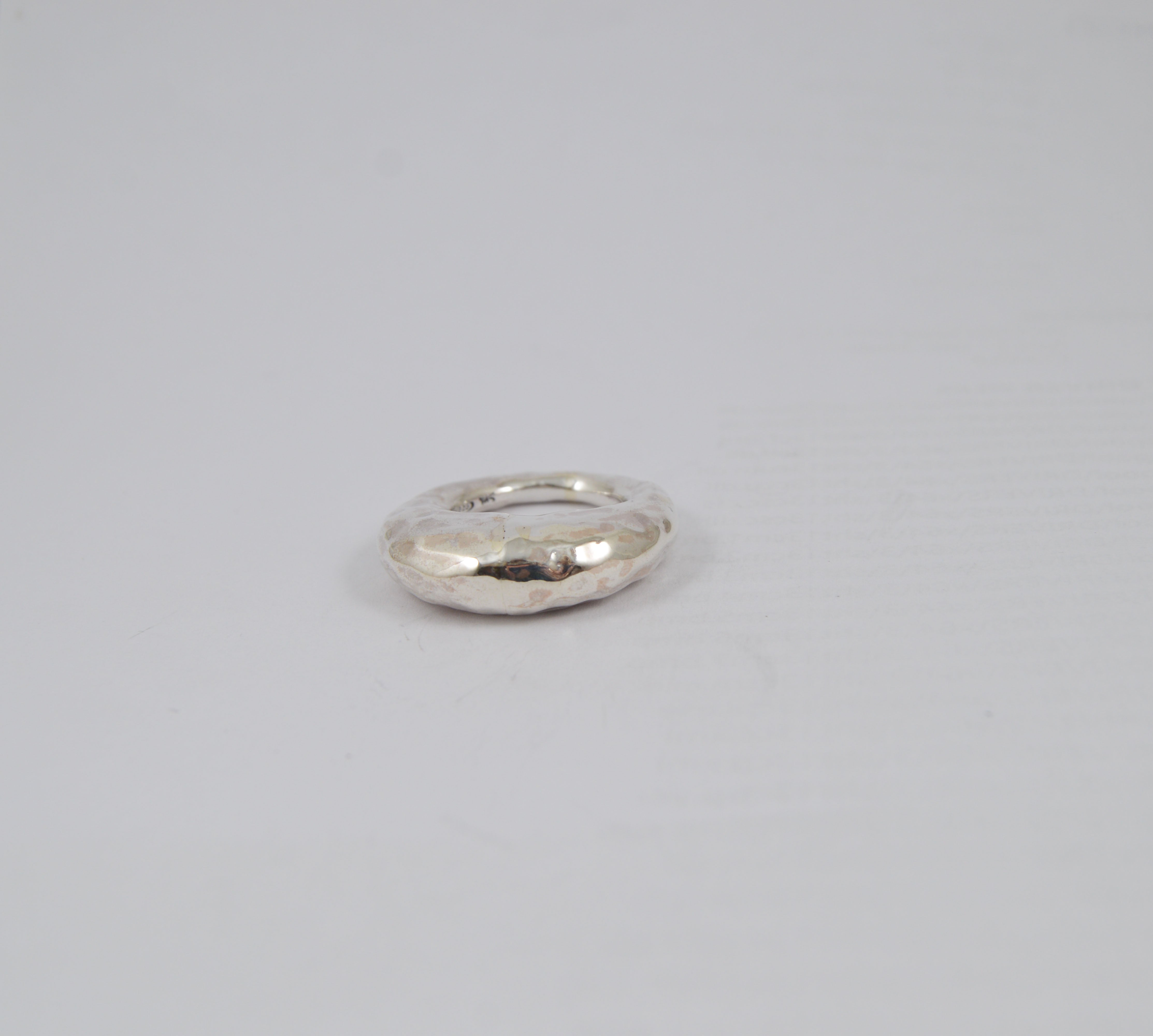 Rosa Maria Brandy Ring displayed at an angle, highlighting its hammered texture and smooth finish for unique elegance.