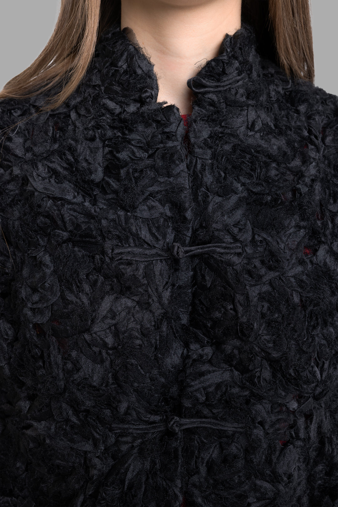 Comme des Garçons women's black ruffled mesh jacket, back view highlighting semi-sheer floral texture and straight hem detail