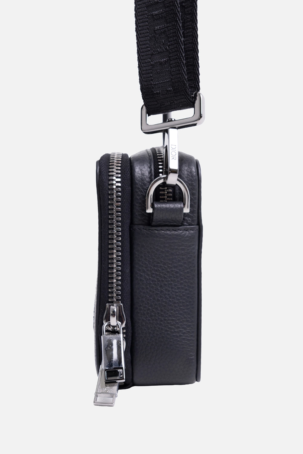 Close-up of Dior x ERL pouch showing Dior logo detail and top zipper closure