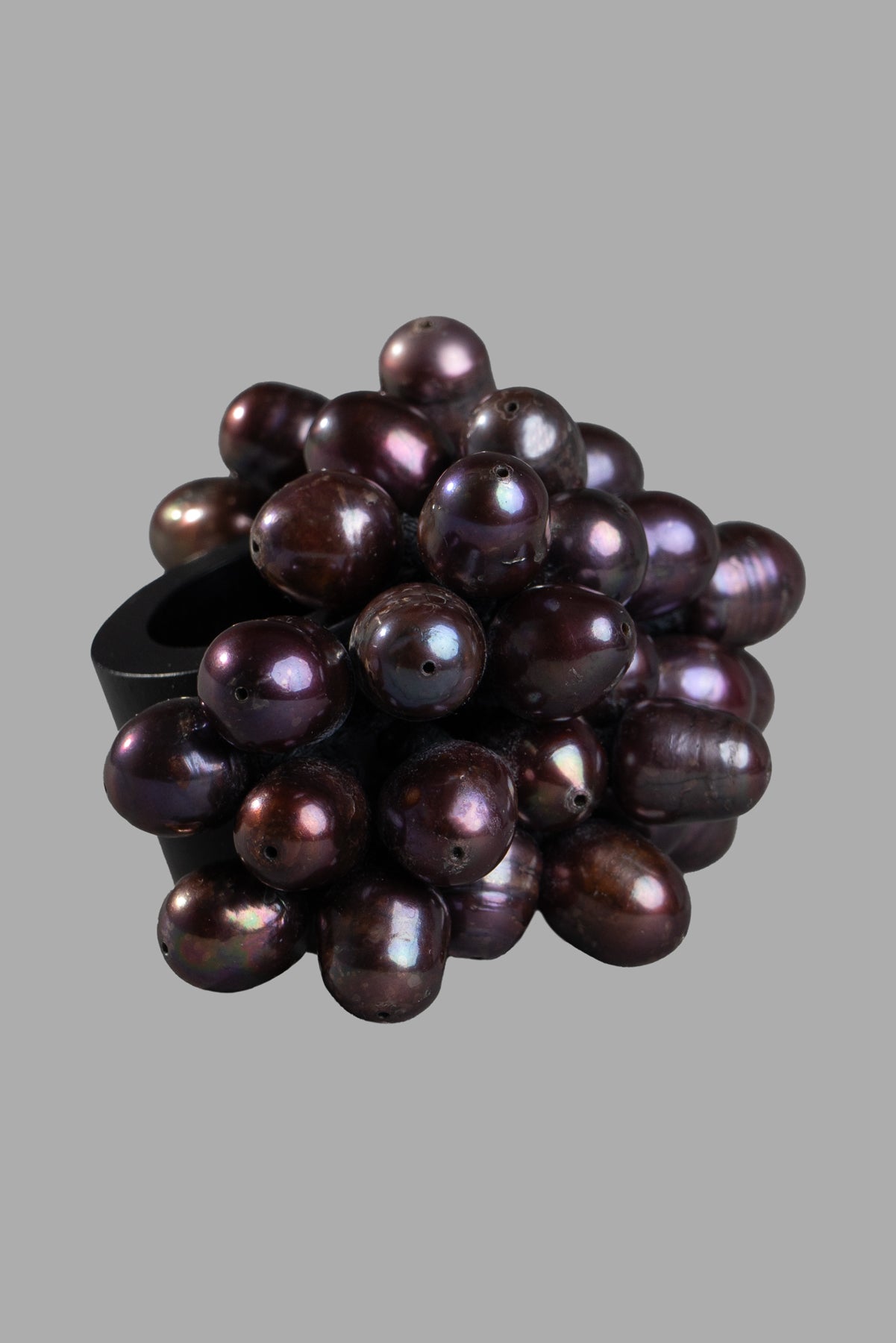 Monies Statement Ring featuring ebony wood with a cluster of black pearls, close-up view.